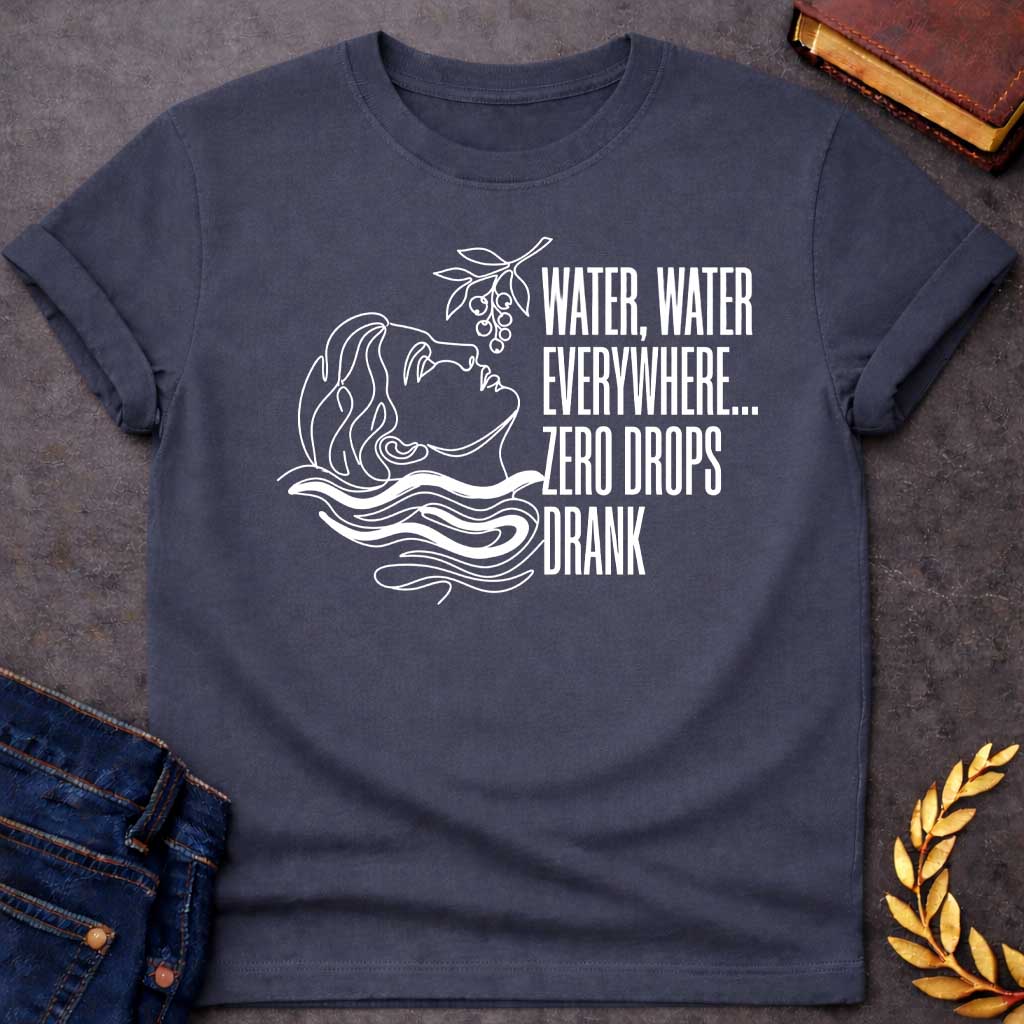 Dark Heather t-shirt with A continuous line-art illustration. Drawn in sleek white outlines with vibrant white water ripples, a classical profile tilts its head back toward a hanging fruit branch just above. Stacked to the right in tall, narrow sans-serif text, the quote reads "WATER, WATER EVERYWHERE... ZERO DROPS DRANK" for a modern, mythological-inspired design.