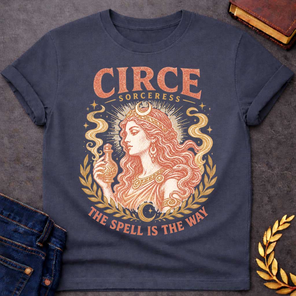Dark Heather t-shirt with a Vintage Greek mythology design featuring Circe, the legendary sorceress, holding a potion bottle with a snake coiled around her arm. Crescent moons, stars, mystical smoke, and laurel branches frame the portrait with the text “Circe Sorceress” and “The Spell Is the Way” in a distressed antique style.