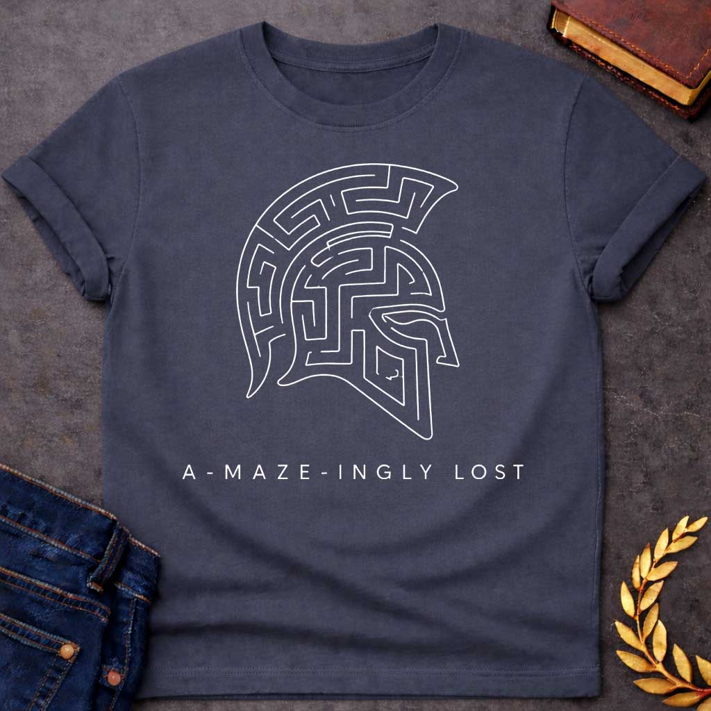 Dark heather T-shirt with A Minimalist line art Spartan warrior helmet composed entirely of intricate maze pathways on a shirt. The crested helmet's interior is filled with convoluted corridors and passages forming a complex labyrinth design. Black and white aesthetic. Text reads 'A-Maze-Ingly Lost' below. Clever wordplay merges Greek mythology and warrior symbolism with the legendary Cretian labyrinth, celebrating getting lost in mazes and ancient Greek warrior culture.