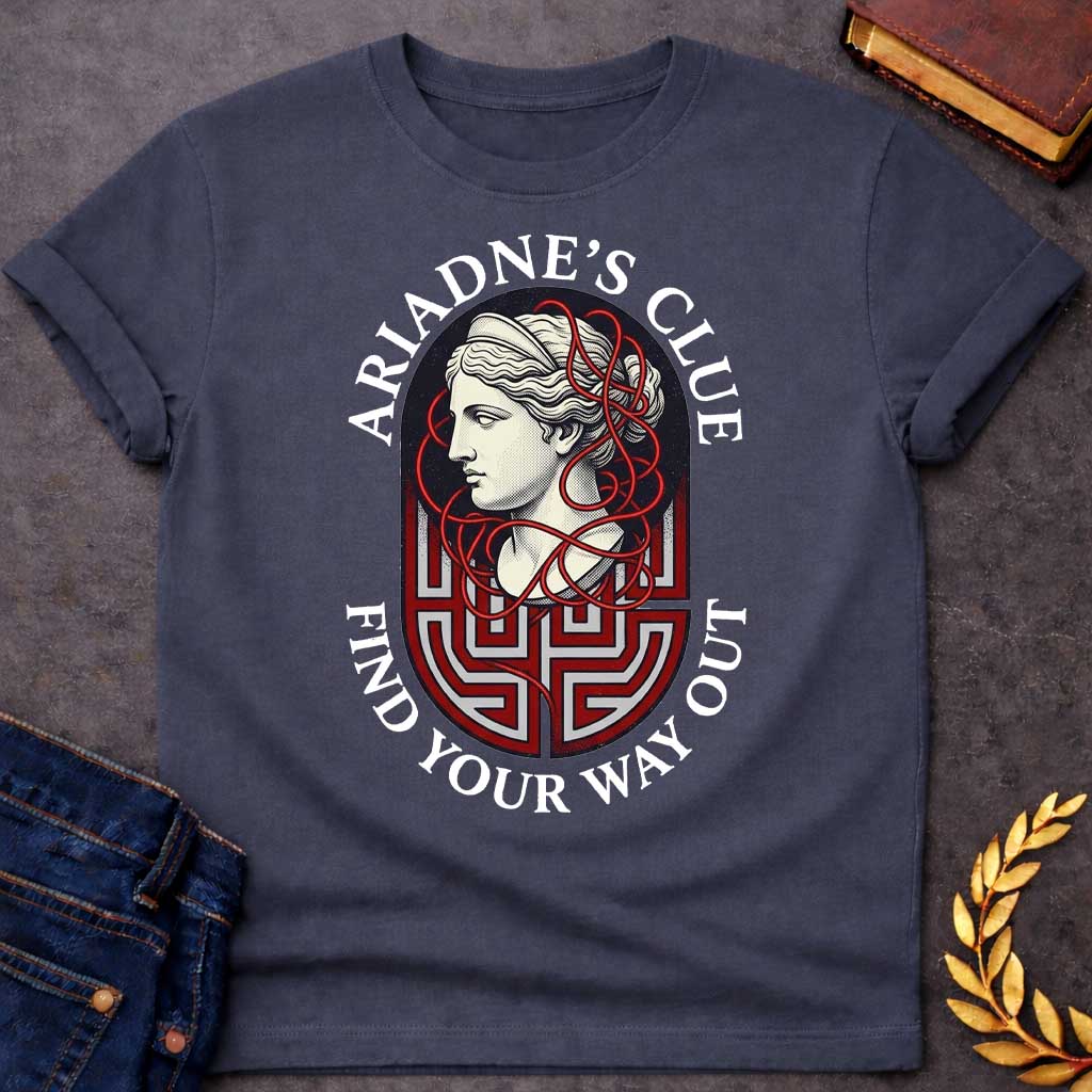 Dark Heather T-shirt with A Classical portrait of Ariadne rendered in cream and red showing her in profile with wavy hair. Red thread winds decoratively around her head and neck, referencing her legendary ball of thread that guided Theseus through the labyrinth. A Greek key maze pattern in red and gray forms the base below her portrait. Text reads 'Ariadne's Clue' above and 'Find Your Way Out' below. Celebrates the mythological heroine's wisdom and the power of guidance through impossible challenges