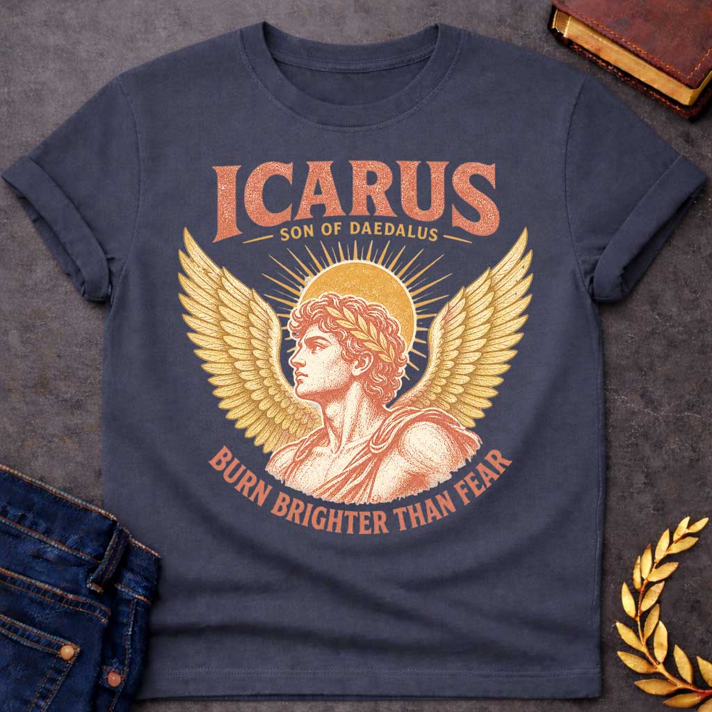 Dark Heather t-shirt with a Vintage Icarus Greek mythology design featuring the son of Daedalus in profile with large golden wings, a laurel crown, and a radiant sun behind him. Distressed coral and gold artwork gives the design an antique classical look, with bold text reading “Icarus Son of Daedalus” and “Burn Brighter Than Fear.”