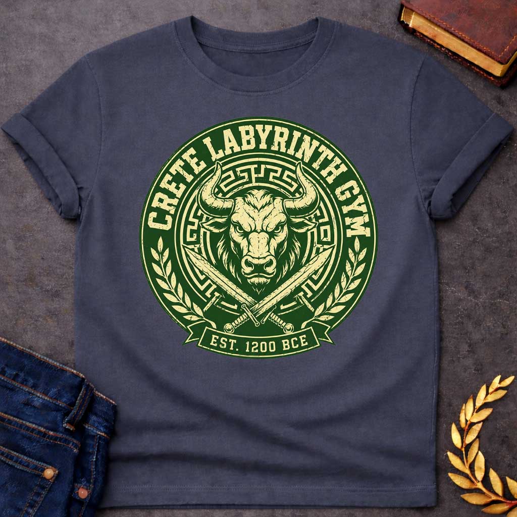 Dark Heather T-shirt with a Fitness emblem of the Minotaur from Crete's Labyrinth. Green and cream circular badge displays a detailed bull head with curved horns within Greek key borders. Two crossed swords flank below. Laurel wreaths frame sides. Text reads 'Crete Labyrinth Gym' and 'Est. 1200 BCE.' Distressed texture adds vintage appeal. Merges Greek mythology with modern gym culture, celebrating legendary warrior strength.