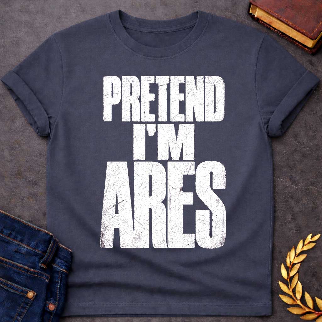 Dark Heather t-shirt with a Pretend I’m Ares Greek mythology design featuring bold distressed white typography on a transparent background. The stacked text reads “PRETEND I’M ARES” in a rugged vintage block font, creating a humorous Greek god design inspired by Ares, the god of war, courage, battle, and martial strength.