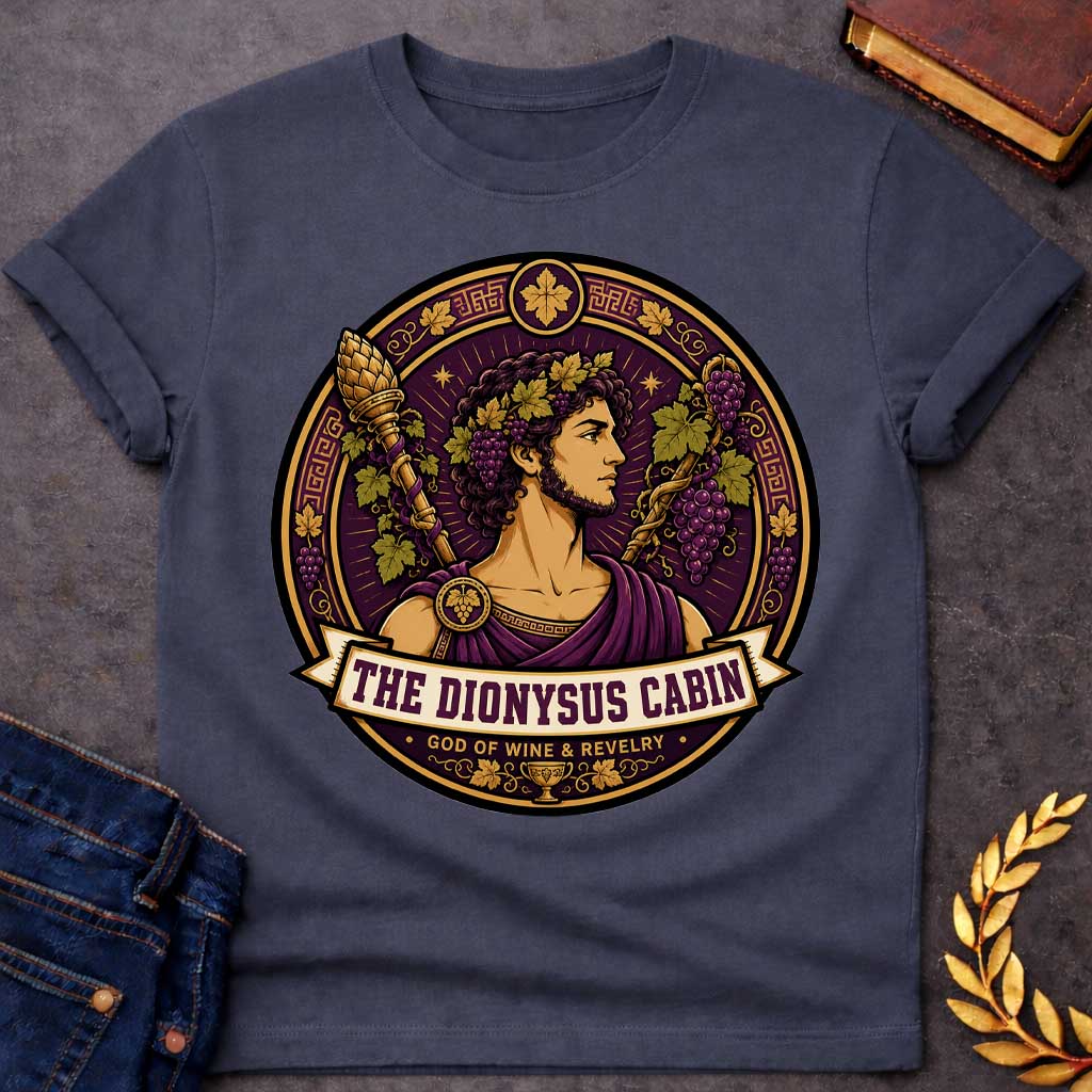 Dark Heather t-shirt with a Dionysus Greek mythology cabin design featuring the god of wine and revelry wearing a grapevine crown and purple robes, surrounded by clusters of grapes, vine leaves, a thyrsus, Greek key patterns, and a wine cup. Purple and gold circular emblem includes the text “The Dionysus Cabin” and “God of Wine & Revelry,”