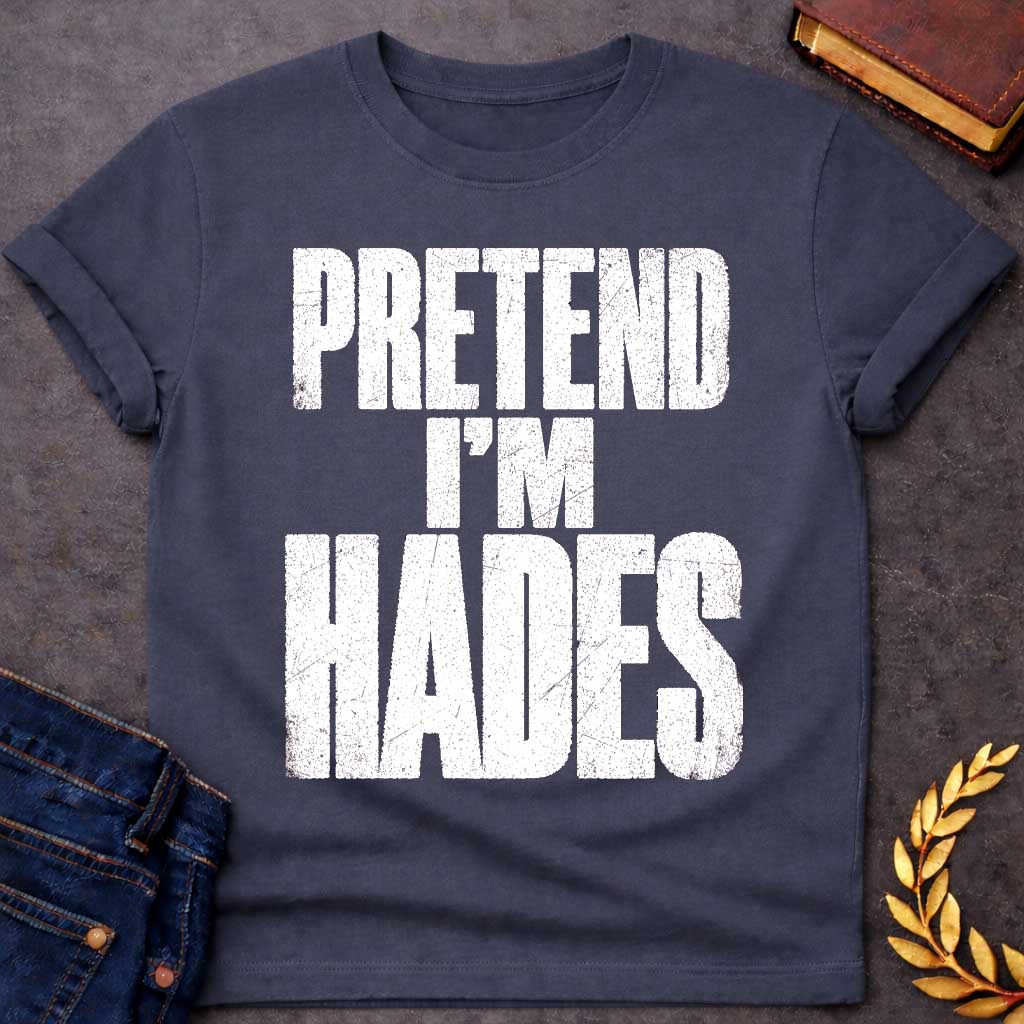 Dark Heather t-shirt with a Pretend I’m Hades Greek mythology design featuring bold distressed white typography on a transparent background. The stacked text reads “PRETEND I’M HADES” in a rugged vintage block font, creating a humorous design inspired by Hades, the Greek god of the underworld, the dead, and riches.