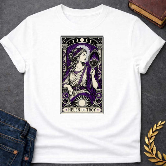 White T-shirt with an intricate tarot card style graphic featuring Helen of Troy in a Dark Academia aesthetic. She wears a laurel wreath, Greek tunic, and purple robe, holding a hand mirror that reflects a burning city in purple flames. The design has a black, cream, and deep purple color scheme with mystical elements like moon phases, a radiant sun, and an eye symbol. A banner at the bottom reads "HELEN OF TROY" between two stars