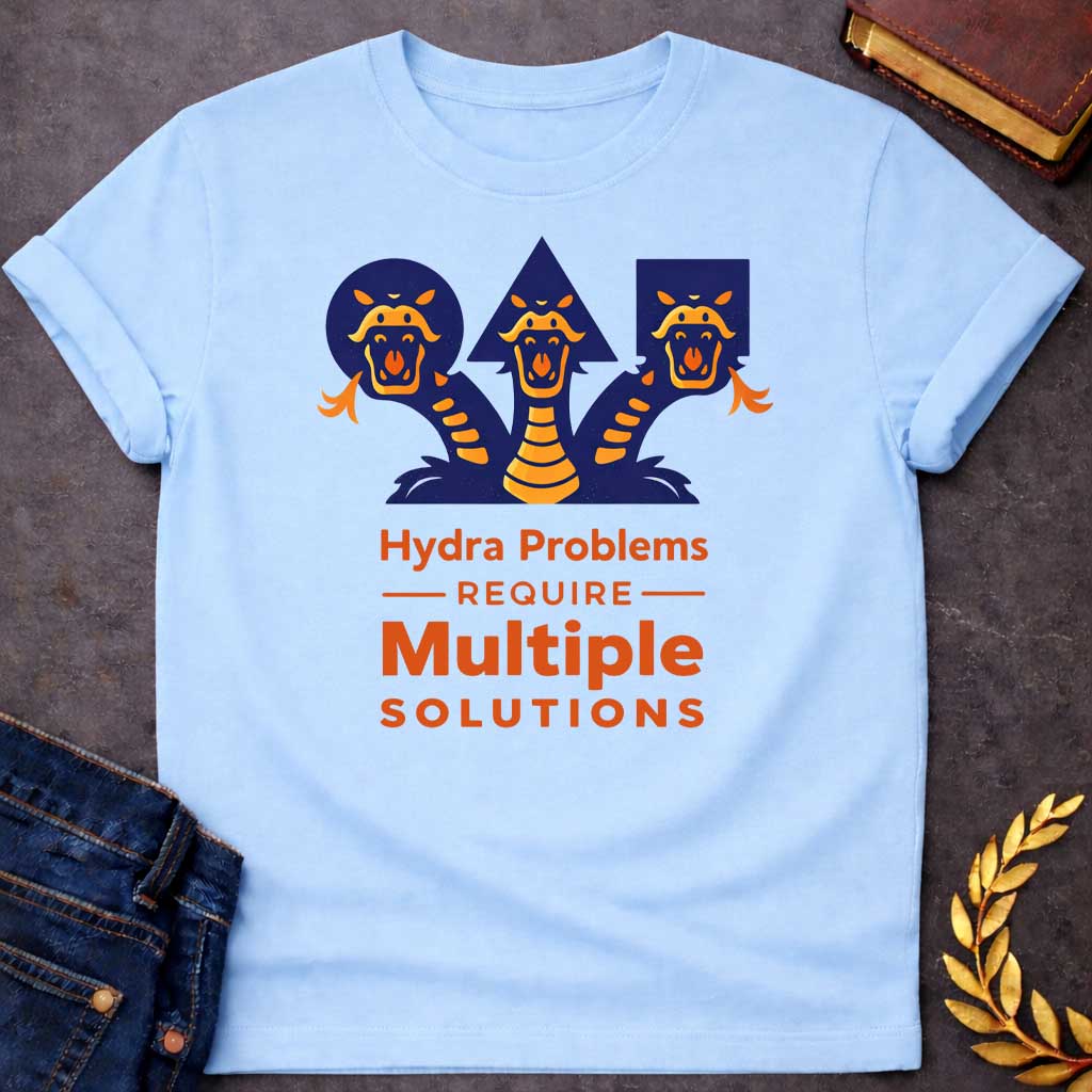 Light Blue T-shirt with a graphic featuring a bold modern illustrated design of the Hydra, the multi-headed serpent of Greek mythology, depicted as three snarling orange and navy snake heads rising against geometric navy shapes a circle, triangle, and rectangle.  Bold orange text below reads "Hydra Problems Require Multiple Solutions" with "Require" flanked by horizontal rules in a smaller weight