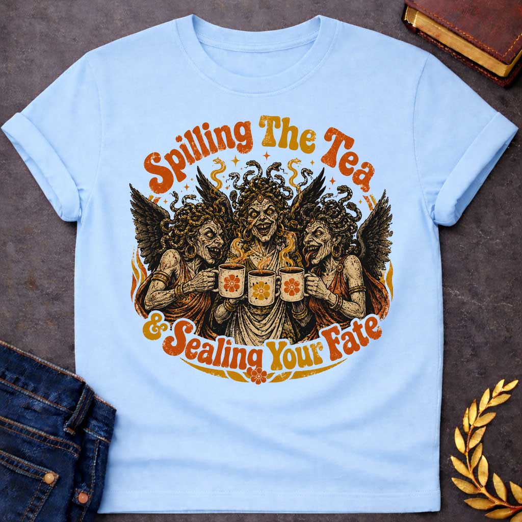 Light Blue T-shirt with a Humorous illustration blending modern gossip culture with Greek mythology. Three Furies with serpent hair and black wings wear classical robes, each holding a decorative tea cup with floral designs. Their expressions are menacing yet mischievous. Text reads 'Spilling The Tea & Sealing Your Fate.' Black, cream, orange, and gold color scheme with decorative flourishes. Playfully references both tea-spilling gossip and divine vengeance and fate.