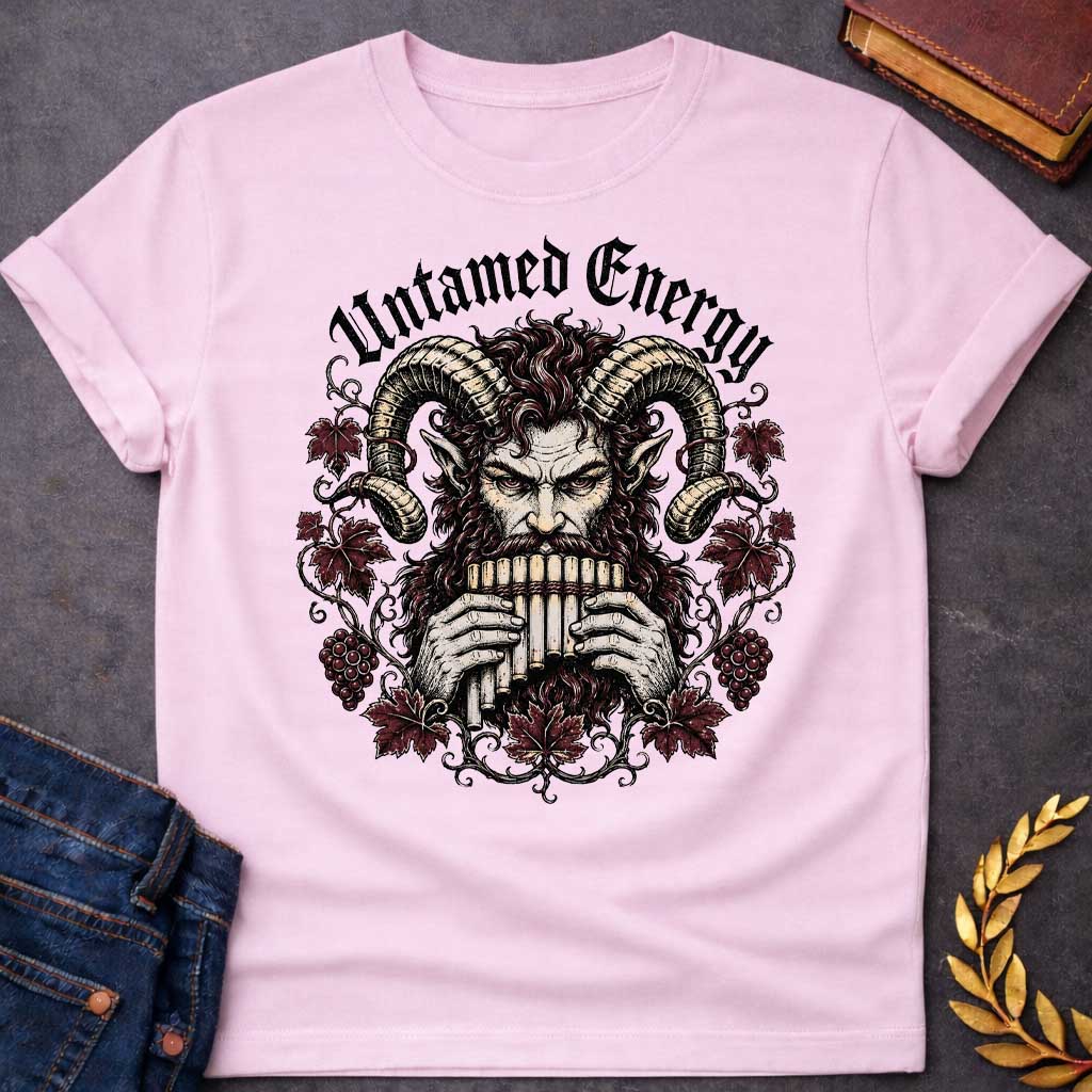 Light Pink T-shirt with a heavy metal style t-shirt graphic. It features a powerful, intense satyr or Pan figure with large, curling ram horns playing a pan flute. His fierce face is framed by a circular wreath of detailed, twisting grapevines, deep purple-red autumn leaves, and clusters of grapes. Arched directly above the illustration, the phrase "Untamed Energy" is written in a bold, black gothic font