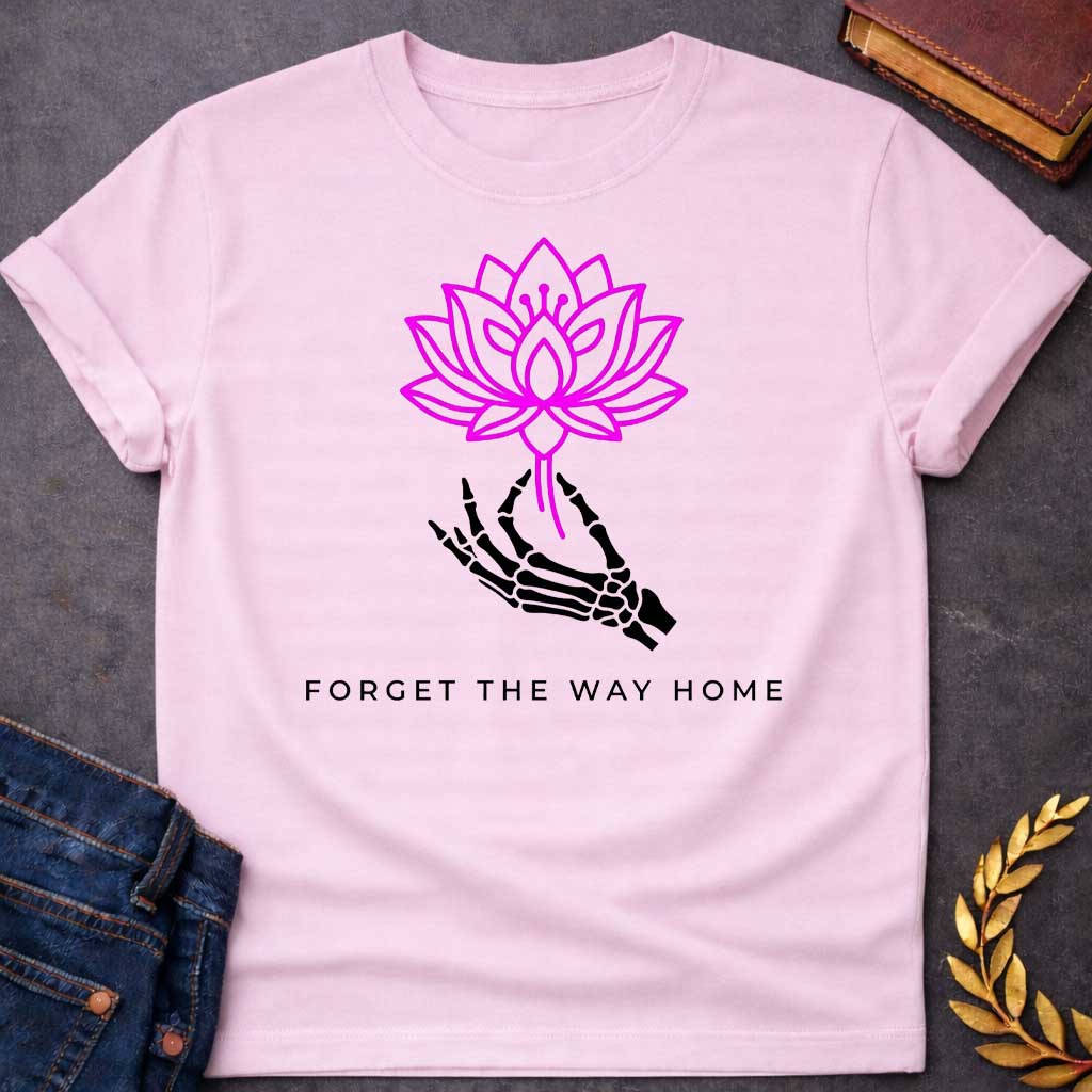 Light Pink T-shirt with a graphic featuring a bold magenta line-art lotus flower held delicately by a black skeletal hand, with spaced bold sans-serif text below reading "Forget the Way Home" — a darkly humorous reference to the Land of the Lotus-Eaters episode in Homer's Odyssey, where Odysseus's crew ate lotus flowers and forgot their desire to return home