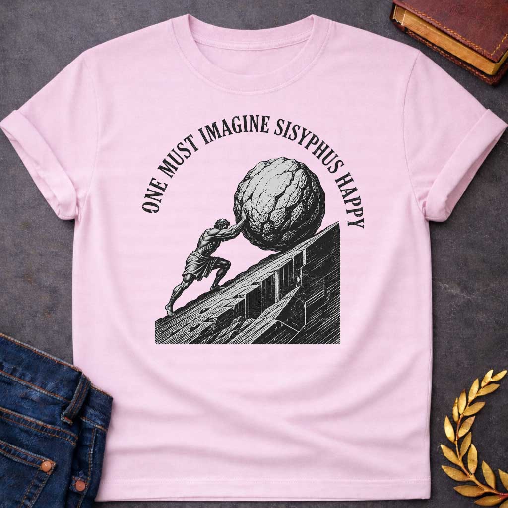 Light Pink T-Shirt with a high-contrast, black-and-white graphic design. The illustration features a woodcut-style depiction of Sisyphus straining to push a massive, craggy boulder up a steep, jagged mountainside. Arched in a bold, weathered serif font over the top of the illustration is the text "ONE MUST IMAGINE SISYPHUS HAPPY,"