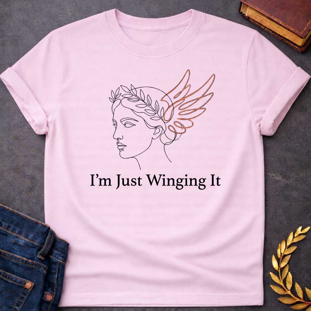 Light Pink T-shirt with a Minimalist line art illustration of a classical Greek profile with a laurel wreath crown and large terracotta-colored wings extending from the head. Elegant continuous line drawing style. Text reads 'I'm Just Winging It' in serif font below. References Nike, the goddess of victory, with a humorous modern spin. Blends classical mythology with relatable contemporary humor about improvisation and navigating life without a plan.