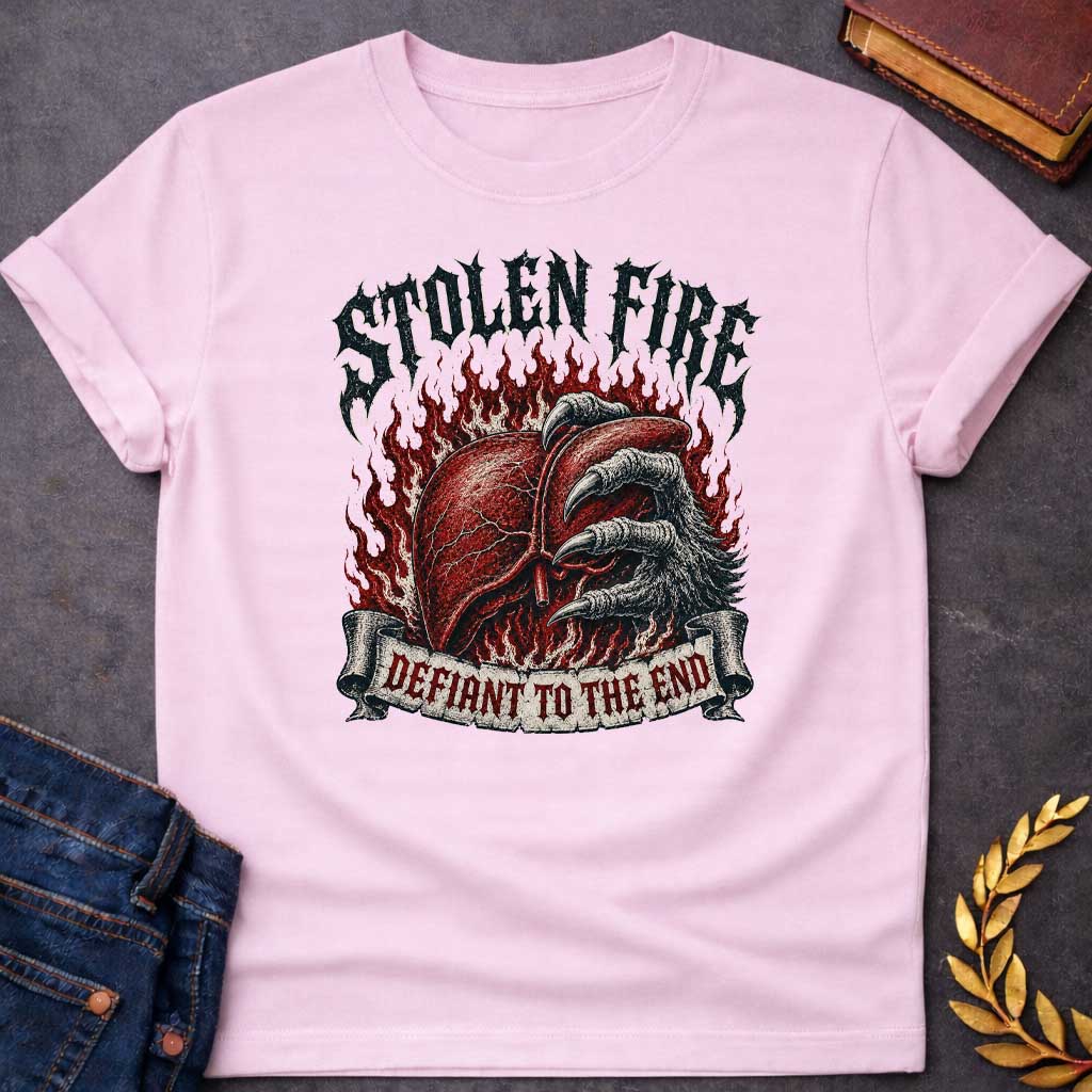Light Pink T-shirt with a heavy metal style graphic referencing Prometheus. It features a detailed, anatomical human liver gripped tightly by a large, feathered eagle claw, set against a background of roaring red flames. At the top, the words "STOLEN FIRE" are written in a jagged, distressed black metal font. A weathered scroll banner across the bottom reads "DEFIANT TO THE END" in a sharp, red gothic typeface.