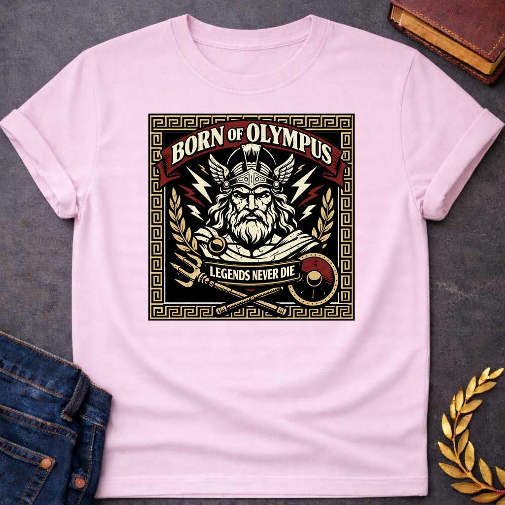 Light Pink T-shirt graphic featuring a bold vintage label-style design with a Greek meander border in gold. A red arched banner at the top reads "Born of Olympus" above a front-facing illustration of Zeus with long white hair and beard wearing a winged helmet, surrounded by radiating lightning bolts and flanked by golden laurel branches. A crossed trident and scepter with a red shield sit below, with a scroll banner reading "Legends Never Die," rendered in black, gold, cream, and red tones