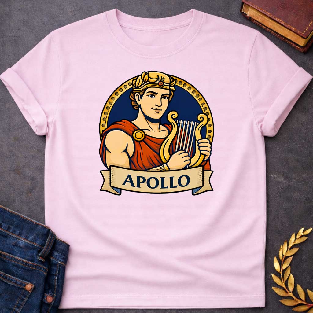 Light Pink T-shirt graphic featuring a vibrant illustrated portrait of Apollo, the Greek God of the Sun and Music, with short curly hair and a gold laurel crown, wearing a red draped robe fastened with a gold brooch, playing a golden lyre. He is framed within a gold circular border against a navy background, with a scroll banner below reading "Apollo," in a bold tattoo-inspired style with navy, gold, and red tones