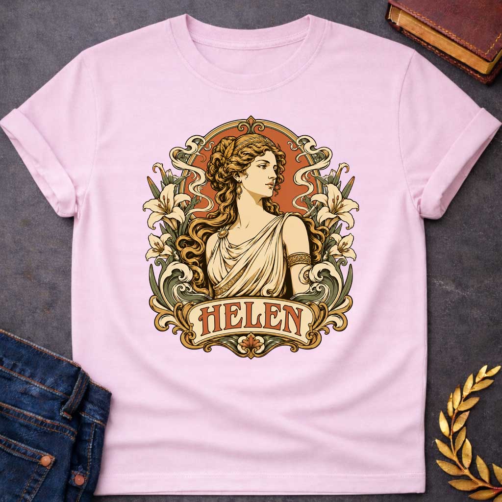 Light Pink T-shirt with an Art Nouveau style t-shirt graphic featuring a profile portrait of Helen of Troy. She has flowing wavy hair, a gold headband, and an elegant cream-colored Greek chiton. The design is framed by an ornate, vintage border decorated with blooming white lilies and flowing ribbons. At the bottom, an elegant banner displays the name "HELEN" in an antique font, featuring a warm terracotta and muted green color palette