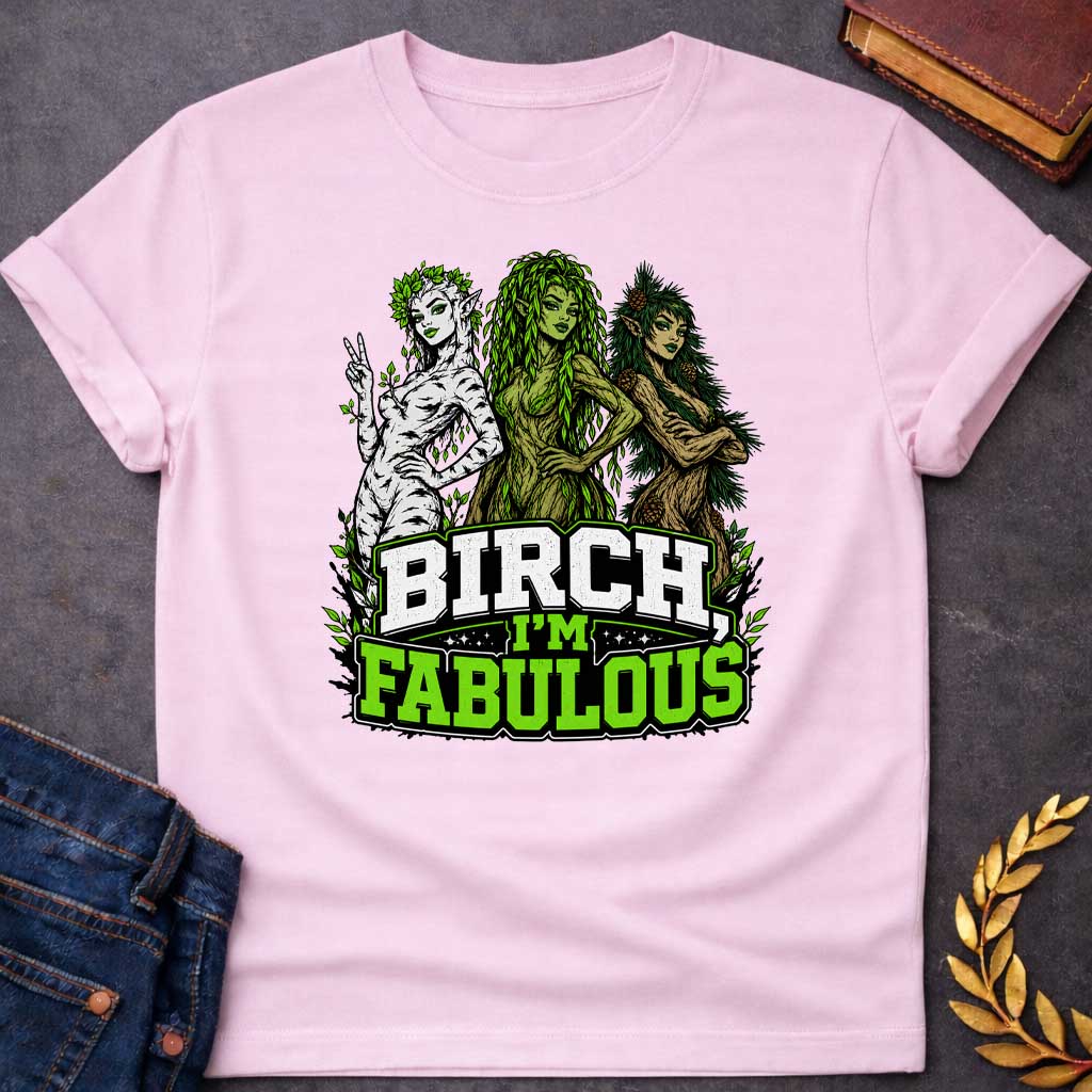 Light Pink T-shirt with a pun-based Greek mythology t-shirt design featuring a detailed engraving-style portrait of a hamadryad emerging from a birch trunk. She has long flowing hair, wears a floral wreath, and looks aside with a dramatic, sassy expression. Arched above her head is the bold black text "BIRCH, I'M FABULOUS" in a clean serif font. The entire graphic uses an elegant, fine-line black and white aesthetic