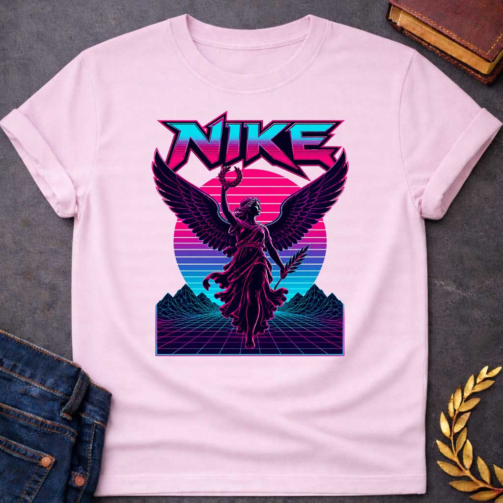 Light Pink T-shirt with a Vaporwave-style illustration of Nike, the Greek goddess of victory, rendered in neon magenta and cyan. She wears flowing robes with large detailed wings, holding a laurel wreath and palm frond. Bold angular text 'NIKE' appears above in magenta lettering. Geometric mountains and grid landscape create a synthwave aesthetic. Horizontal gradient bands in magenta, purple, and cyan evoke 1980s digital design. Blends classical mythology with modern vaporwave art.