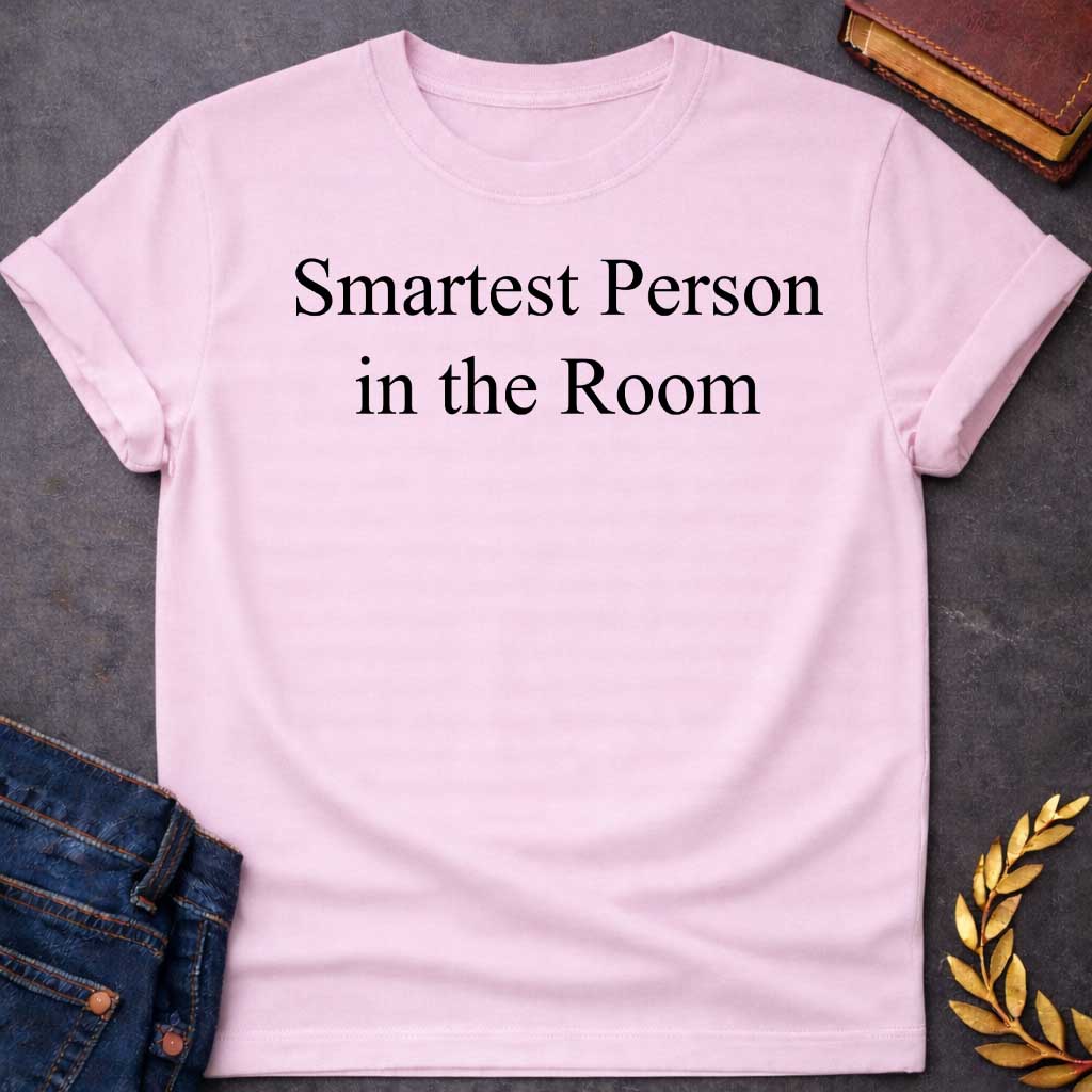 Light Pink Dark Heather T-shirt graphic in black featuring large elegant serif text reading "Smartest Person in the Room" — a confident nod to Athena, the Greek Goddess of Wisdom