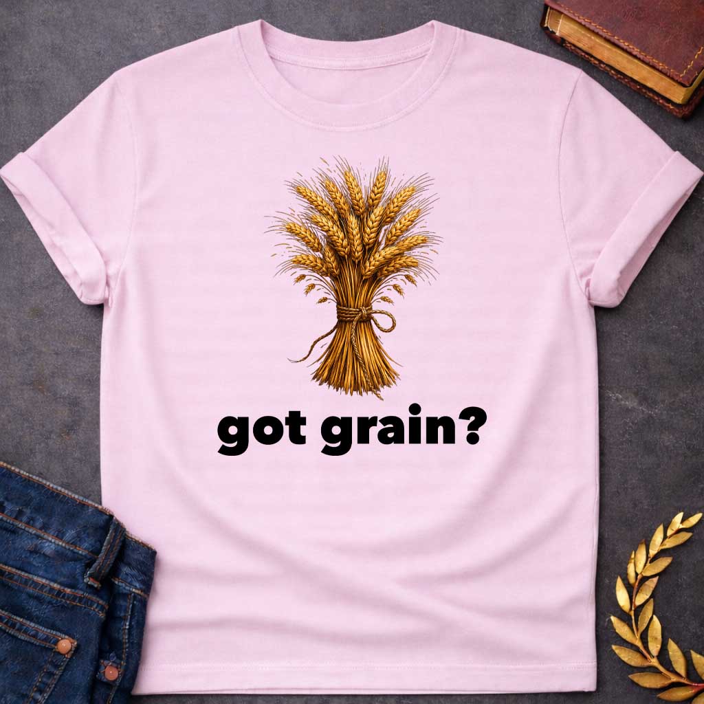Light Pink T-shirt graphic featuring a detailed realistic illustration of a golden wheat sheaf tied together with a twisted rope bow, set against a white background, with bold black text below reading "got grain?" in a humorous nod to Demeter, Greek Goddess of the Harvest