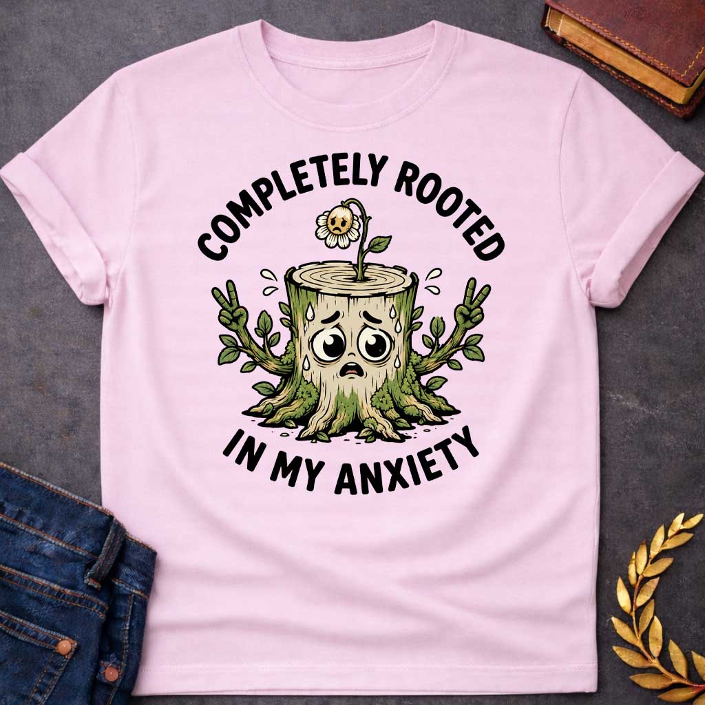 Light Pink T-shirt with a cottagecore-style Greek mythology t-shirt design featuring an engraving illustration of a dryad. The flowing hair intricately weaves into a robust network of tree roots below. Arched elegantly above the portrait is the text "COMPLETELY ROOTED" in a clean black serif font.