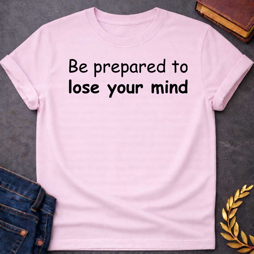 Light Pink T-shirt graphic black text featuring large rounded friendly sans-serif text reading "Be prepared to lose your mind" — a humorous warning referencing Dionysus, the Greek God of Wine and Madness, whose worship was associated with ecstatic frenzy and altered states