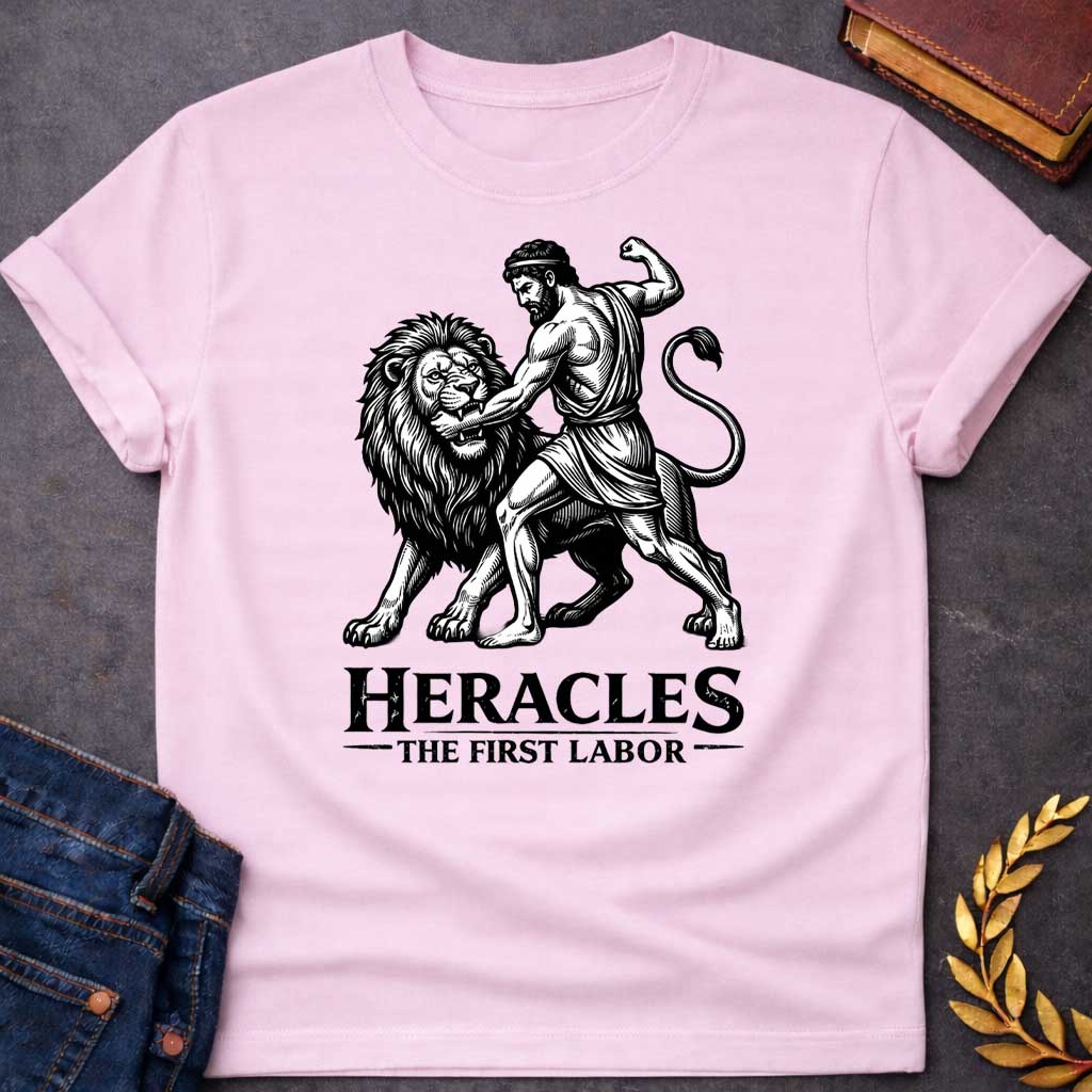 Light Pink T-shirt. The illustration features a woodcut-style depiction of the Greek hero Heracles wrestling the Nemean lion. Below the artwork, the text reads in black "HERACLES" in a large, distressed serif font, followed by the smaller subtitle "THE FIRST LABOR,"