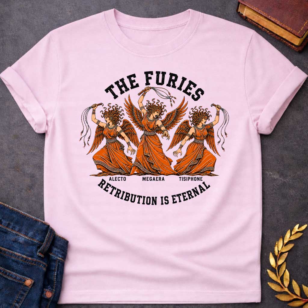 Light Pink T-shirt with an Illustration of the three Furies, the Greek goddesses of vengeance. Three winged female figures with serpent hair wear orange draped robes with Greek key patterns. Each carries whips as instruments of punishment. Named left to right: Alecto, Megaera, and Tisiphone. Rendered in black and orange with classical details. Text reads 'THE FURIES' above and 'RETRIBUTION IS ETERNAL' below, celebrating divine justice and eternal consequences for wrongdoing.