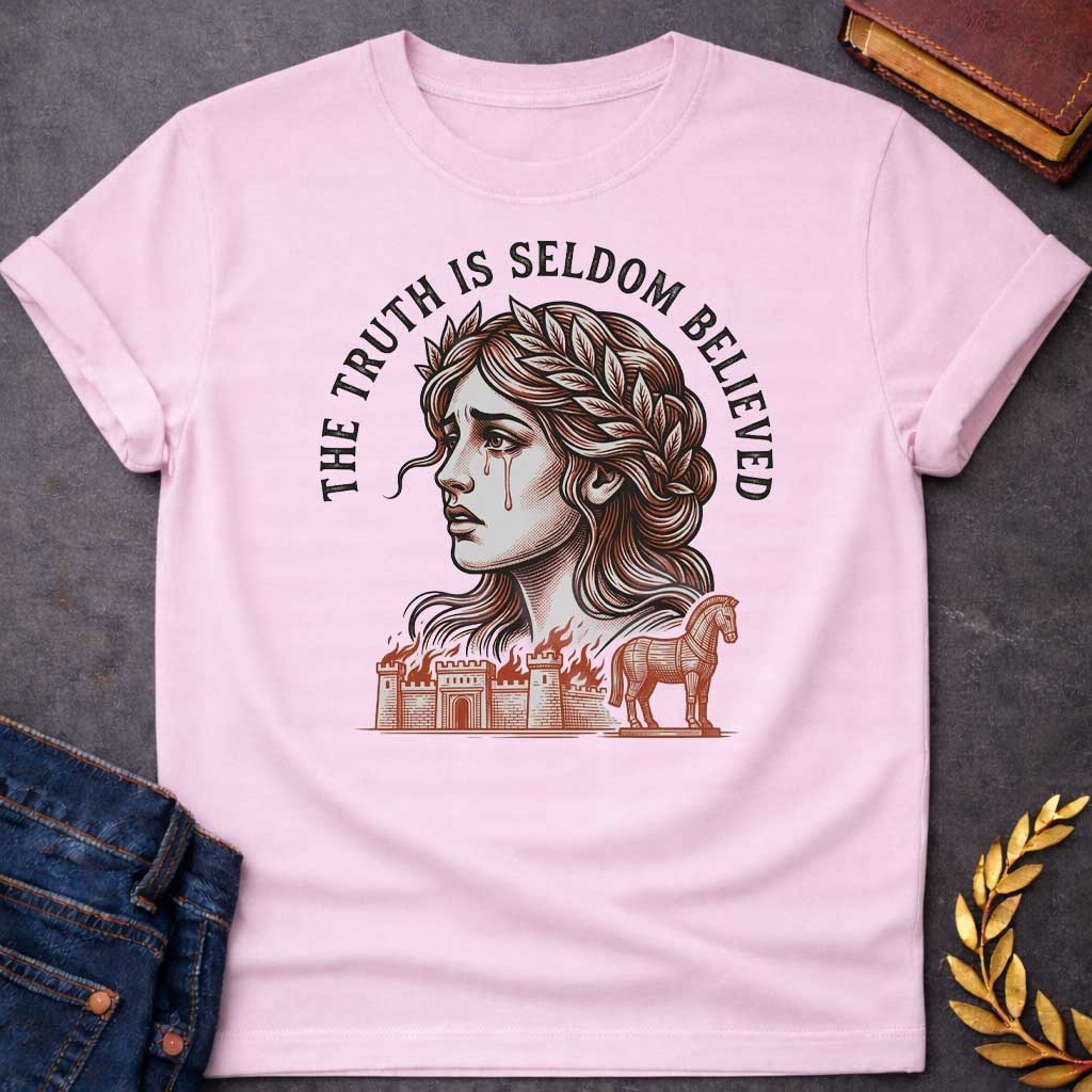 Light Pink T-shirt with a A Greek mythology design featuring a detailed woodblock-engraving style illustration of a crying Cassandra in profile. She wears a laurel wreath, with tears streaming down her face. Arched above her is the text "THE TRUTH IS SELDOM BELIEVED" in a bold black serif font. Below her portrait, a burning ancient city wall and the Trojan Horse are illustrated in a fine-line, terracotta-orange style.
