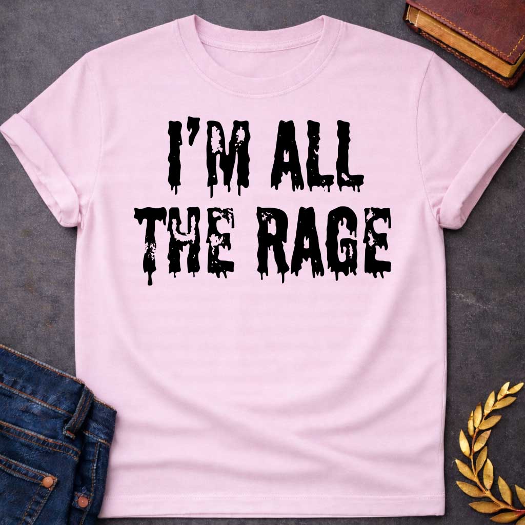 Light Pink T-shirt graphic in black featuring large dripping horror-style text reading "I'm All the Rage" — a double entendre playing on both popular trends and the furious wrath of Ares, the Greek God of War, rendered in a distressed melting font