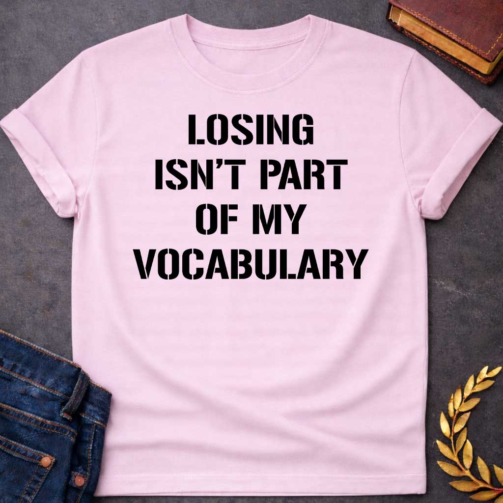 Light Pink Black T-shirt graphic in black featuring bold military stencil-style text reading "Losing Isn't Part of My Vocabulary" — a motivational phrase referencing Ares, the Greek God of War