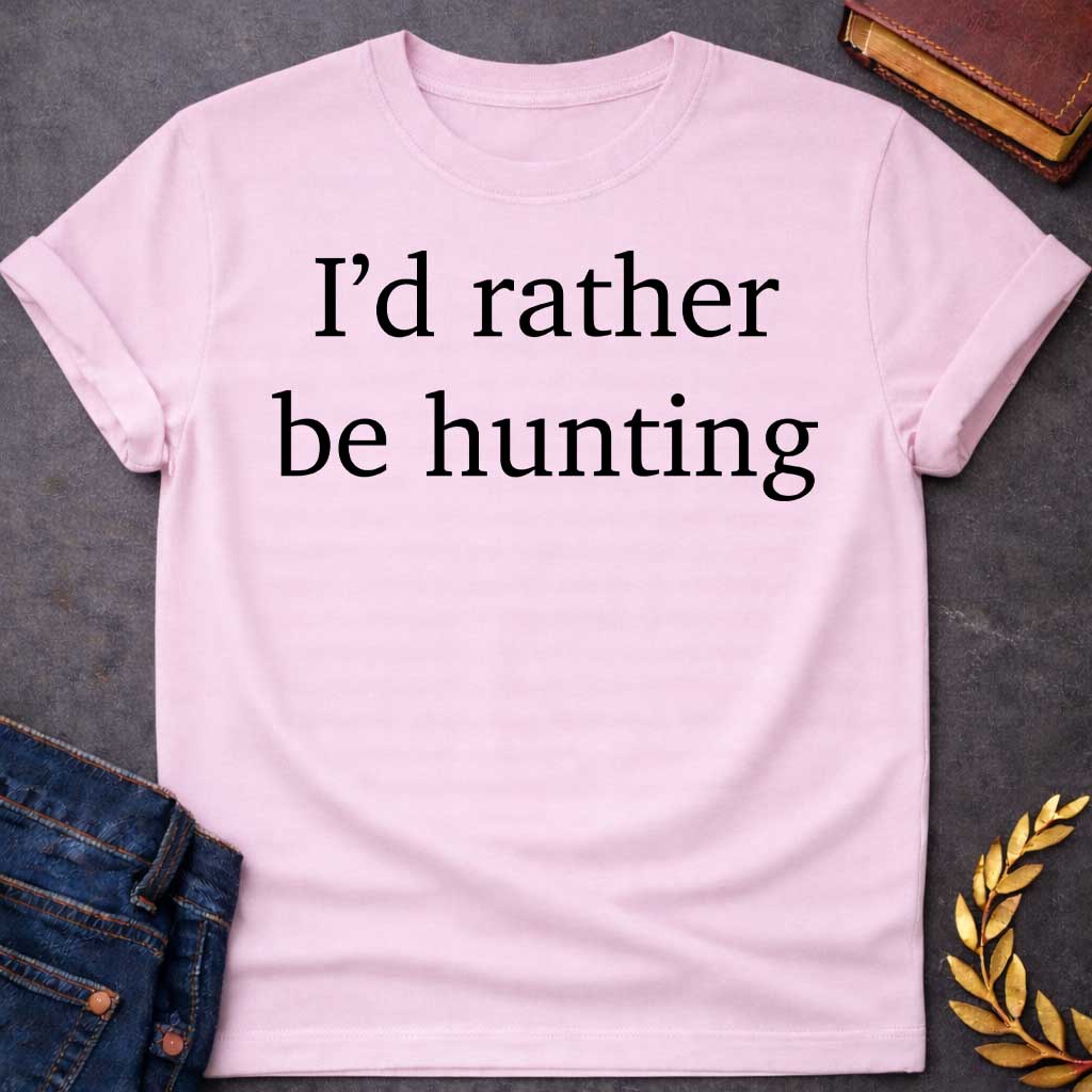 Light Pink T-shirt graphic black featuring large clean serif text reading "I'd rather be hunting" — a humorous nod to Artemis, the Greek Goddess of the Hunt