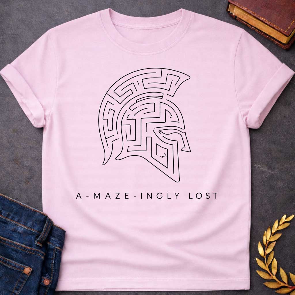 Light Pink T-shirt with A Minimalist line art Spartan warrior helmet composed entirely of intricate maze pathways on a shirt. The crested helmet's interior is filled with convoluted corridors and passages forming a complex labyrinth design. Black and white aesthetic. Text reads 'A-Maze-Ingly Lost' below. Clever wordplay merges Greek mythology and warrior symbolism with the legendary Cretian labyrinth, celebrating getting lost in mazes and ancient Greek warrior culture.