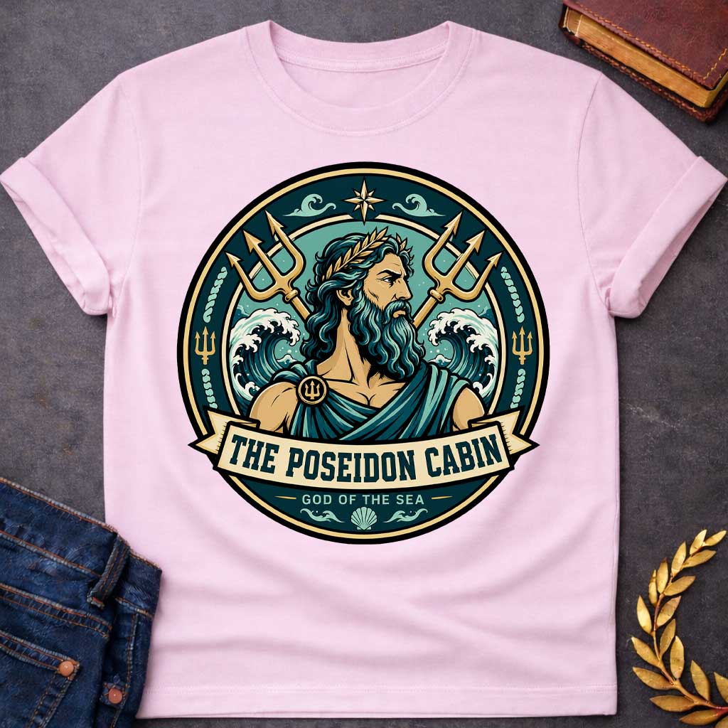 Light Pink t-shirt with a Poseidon Greek mythology cabin design featuring the bearded god of the sea with a golden laurel crown, crossed tridents, crashing ocean waves, and nautical symbols. Teal, aqua, gold, and black circular camp-style emblem includes the text “The Poseidon Cabin” and “God of the Sea.”