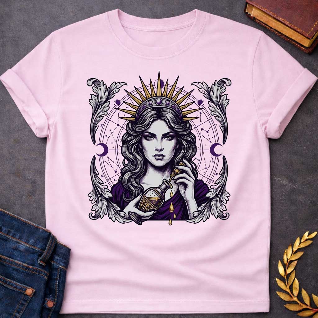 Light Pink T-shirt with a Mystical portrait of Medea rendered in black, purple, and gold holding an ornate potion vessel with glowing liquid dripping downward. Elaborate celestial backdrop features a radiating golden sun crown, purple moon phases, and astrological constellation patterns surrounding her face. Ornate white wing designs frame the composition. Intricate occult aesthetic celebrates the legendary Greek sorceress's magical power, ancient wisdom, and mystical enchantment.