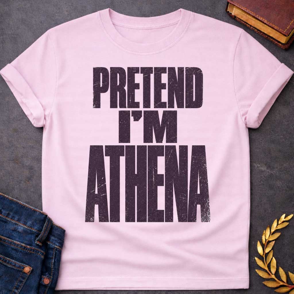 Light Pink t-shirt with a Pretend I’m Athena Greek mythology design featuring bold distressed purple typography on a transparent background. The stacked text reads “PRETEND I’M ATHENA” in a rugged vintage block font, creating a humorous design inspired by Athena, the Greek goddess of wisdom, warfare, strategy, and crafts.