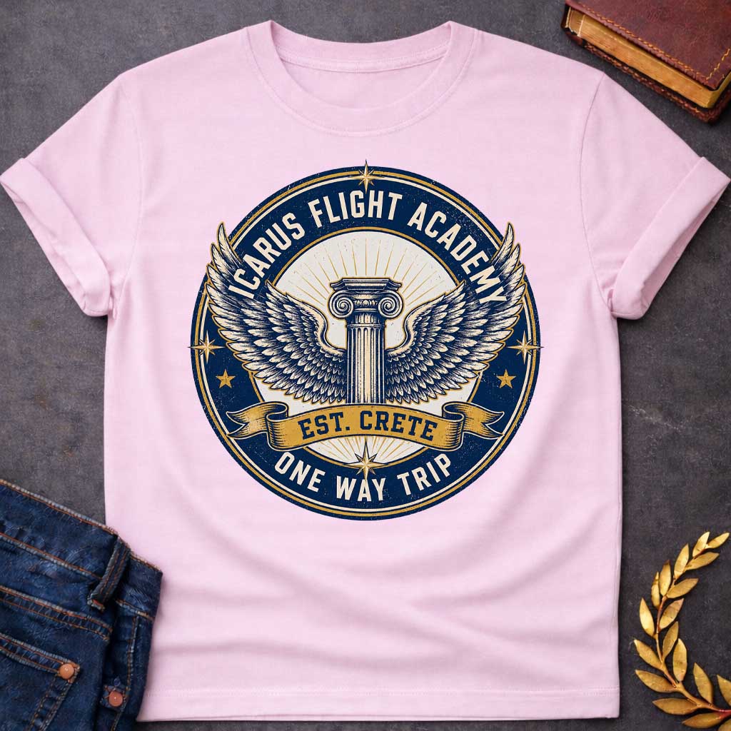 Light Pink t-shirt A circular, distressed vintage emblem design. At the center of a cream circle, a classic Greek Ionic column sprouts a large pair of detailed, spreading wings. A dark blue outer ring features the text "ICARUS FLIGHT ACADEMY" at the top and "ONE WAY TRIP" at the bottom. A golden banner across the center reads "EST. CRETE," adding a dark humor twist to the mythological flight.
