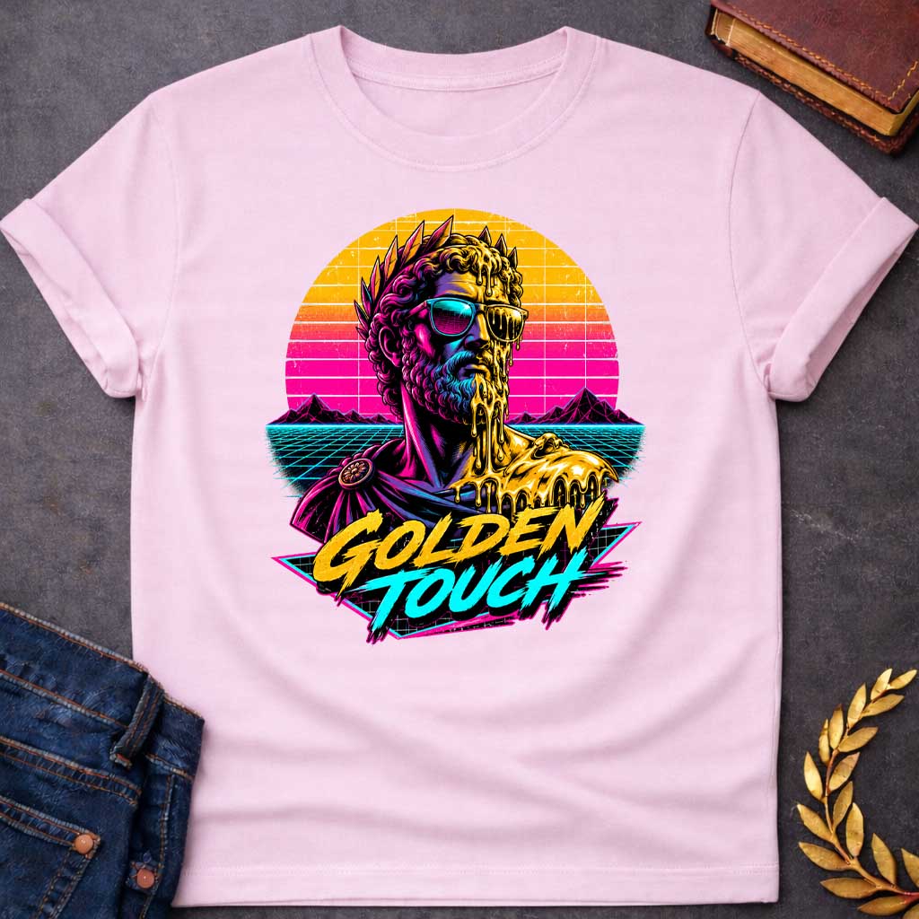 Light Pink t-shirt with A Retro synthwave-inspired Greek mythology design featuring a stylized bust of King Midas wearing sunglasses as molten gold drips over half his face and shoulder. A vibrant neon sunset, grid landscape, and mountains create an 80s vaporwave backdrop. Bold brush lettering reads "Golden Touch" in gold and teal, using bright pink, purple, cyan, and gold for a striking vintage aesthetic.