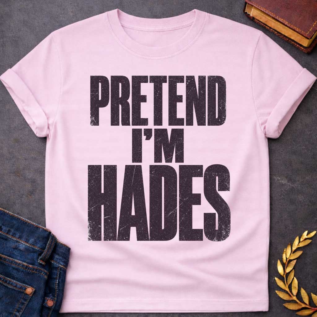 Light Pink t-shirt with a Pretend I’m Hades Greek mythology design featuring bold distressed dark purple typography on a transparent background. The stacked text reads “PRETEND I’M HADES” in a rugged vintage block font, creating a humorous design inspired by Hades, the Greek god of the underworld, the dead, and riches.