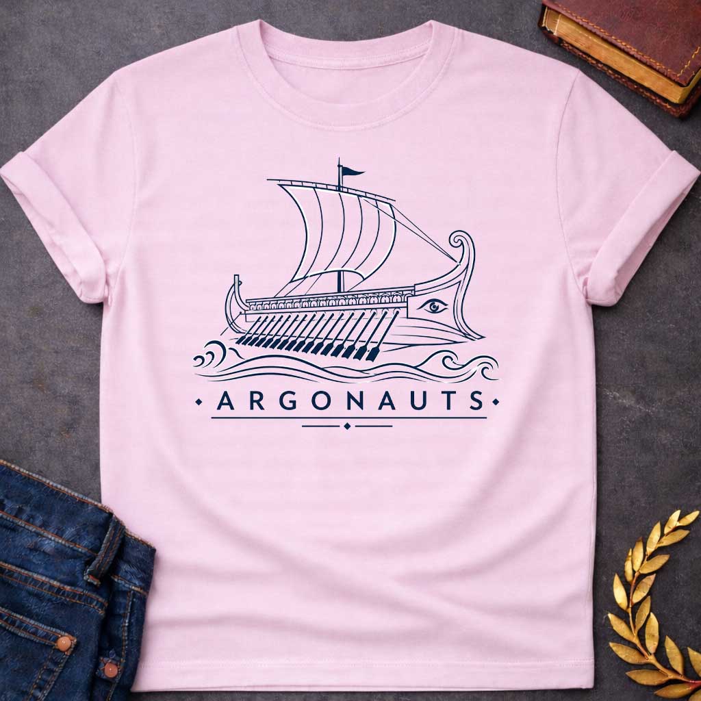 Light Pink T-shirt with A Classical line art rendering of the legendary Argo in navy blue. The Greek ship features billowing sails above a detailed hull with visible oars. Ornate bow and stern decorations frame a protective eye symbol on the hull. Decorative waves flow beneath. Text reads 'Argonauts' with diamond accents. Celebrates the heroic quest of Jason and his crew seeking the golden fleece in ancient Greek mythology.