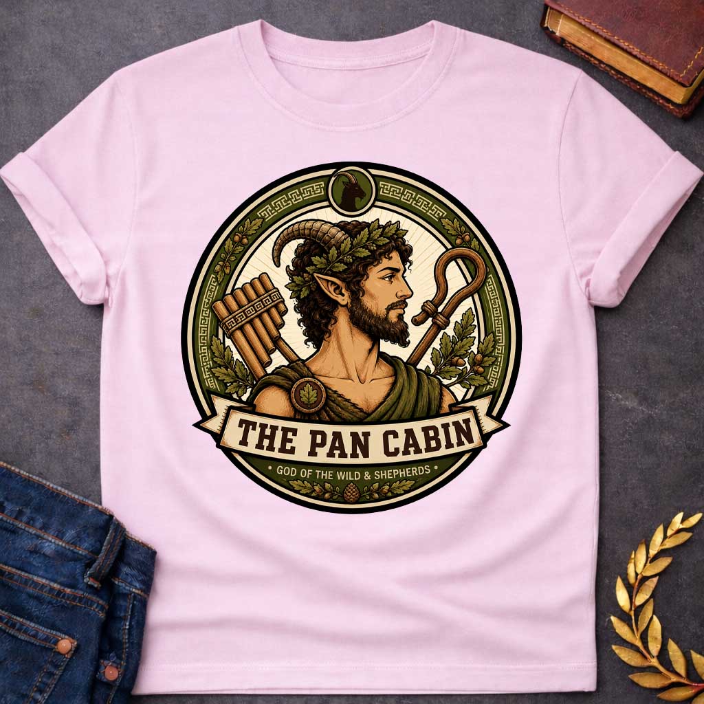 Light Pink t-shirt with a Pan Greek mythology cabin design featuring the god of the wild and shepherds with curved goat horns, pointed ears, leafy crown, and rustic robes. Surrounded by panpipes, a shepherd’s crook, oak leaves, acorns, and Greek key details in an earthy green and gold circular emblem. Text reads “The Pan Cabin” and “God of the Wild & Shepherds,”