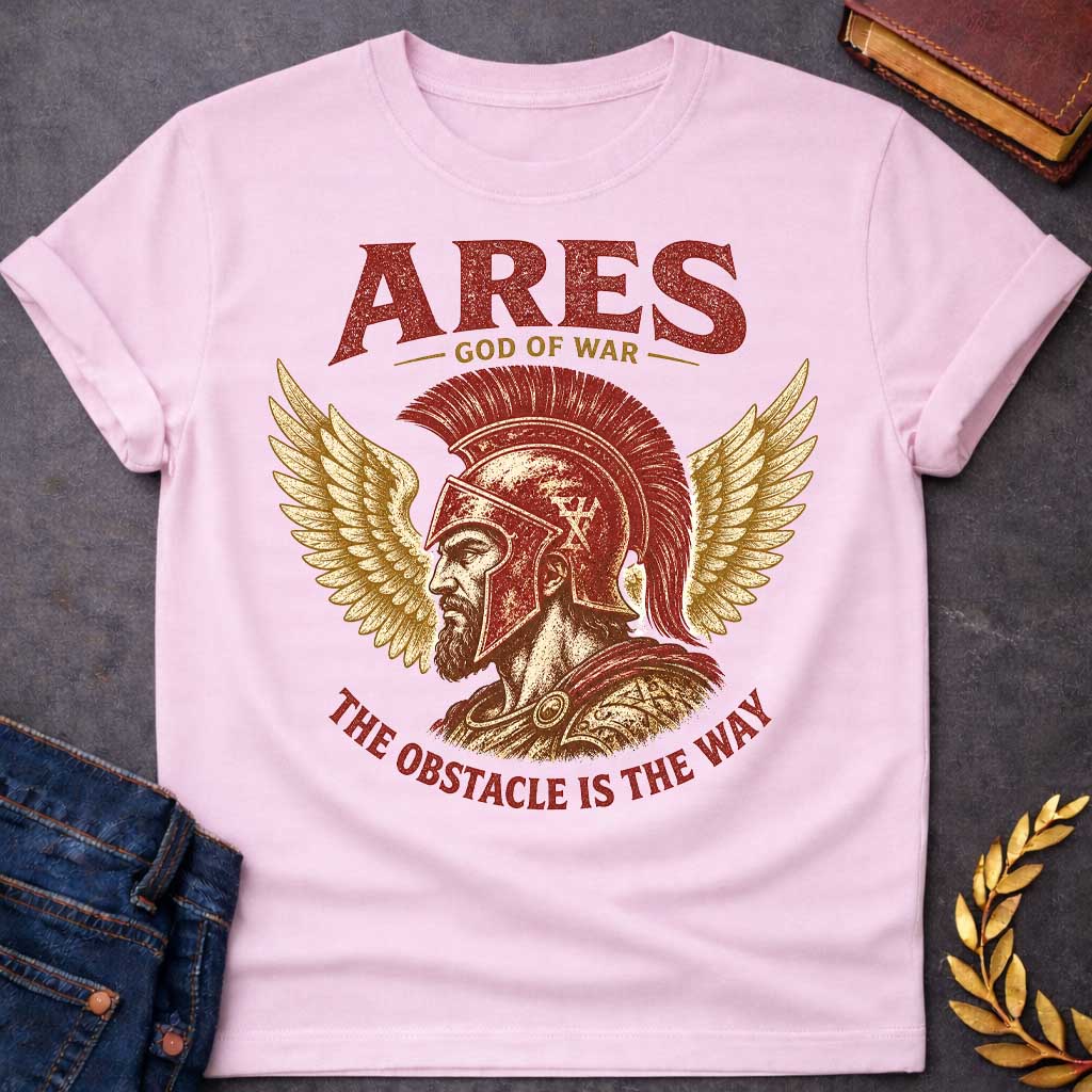 Light Pink t-shirt with a Vintage Greek mythology design featuring Ares, god of war, wearing a battle-worn Greek helmet and armor. Golden wings frame the warrior in a bold red, gold, and cream engraving style. Text reads "Ares – God of War" and "The Obstacle Is the Way," creating a powerful design inspired by strength, courage, and ancient Greek mythology.