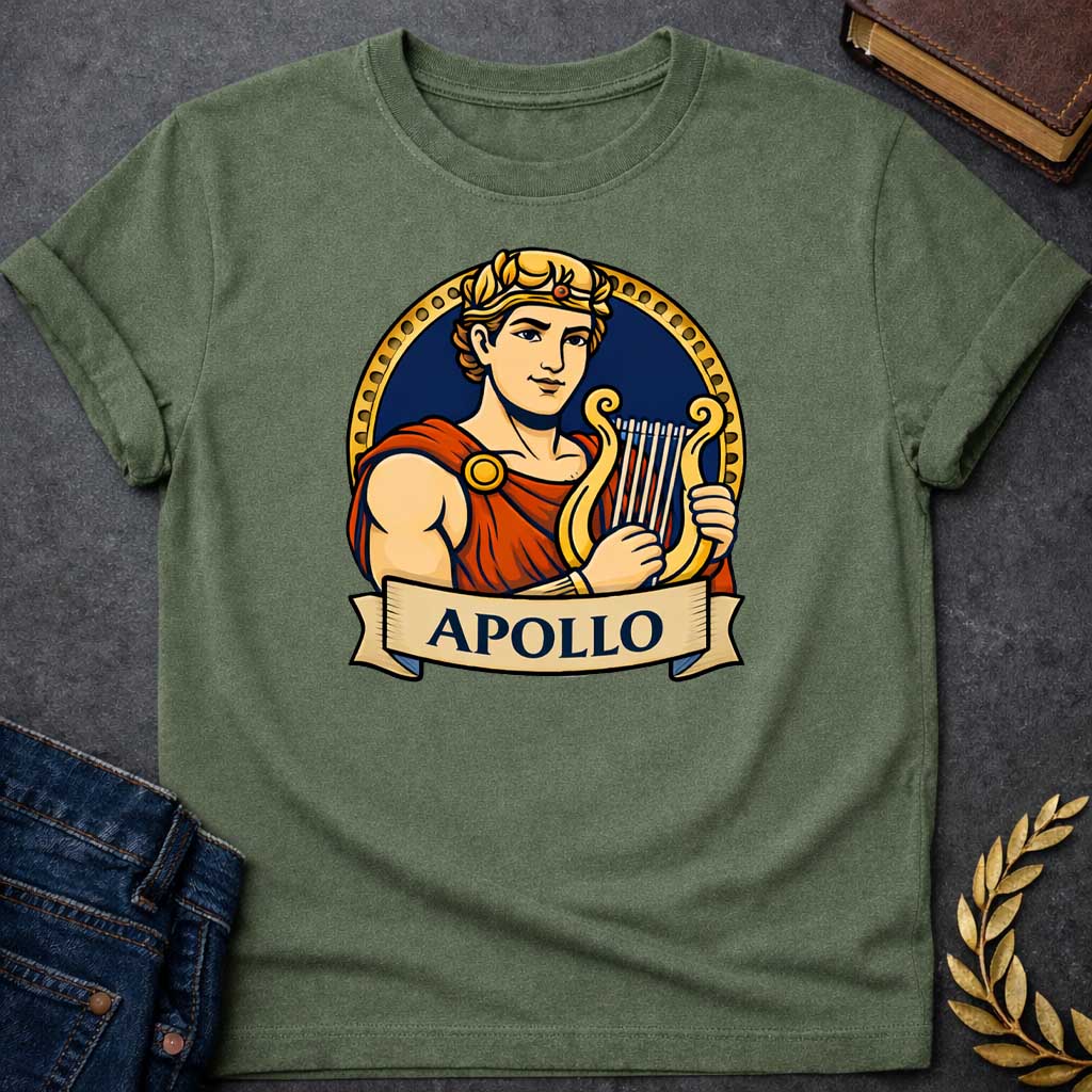 Military Green T-shirt graphic featuring a vibrant illustrated portrait of Apollo, the Greek God of the Sun and Music, with short curly hair and a gold laurel crown, wearing a red draped robe fastened with a gold brooch, playing a golden lyre. He is framed within a gold circular border against a navy background, with a scroll banner below reading "Apollo," in a bold tattoo-inspired style with navy, gold, and red tones
