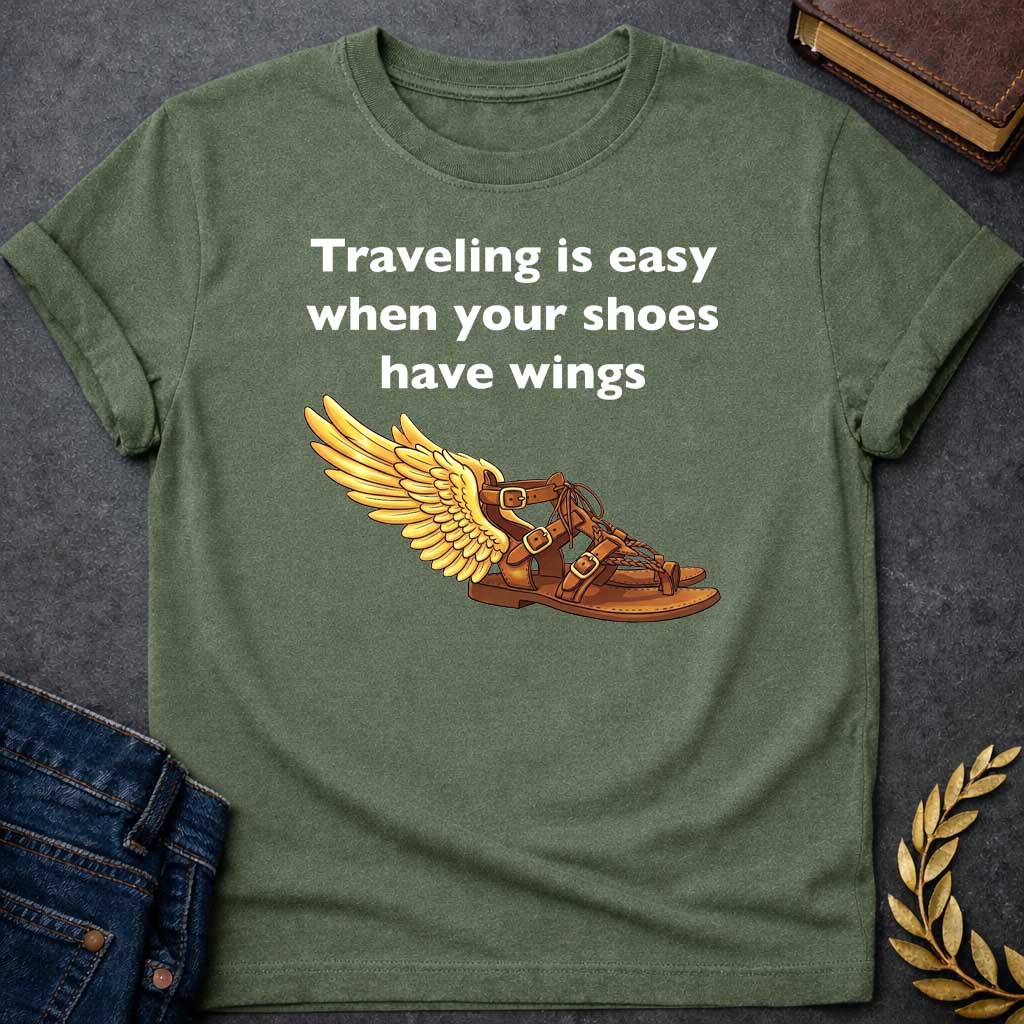 Military Green T-shirt graphic featuring bold white text reading "Traveling is easy when your shoes have wings" above a detailed illustration of Hermes' winged sandal, depicted as a brown leather gladiator sandal with gold buckles and braided lacing, with a large golden wing extending from the ankle — a humorous reference to the talaria, the iconic flying sandals of Hermes, the Greek Messenger God