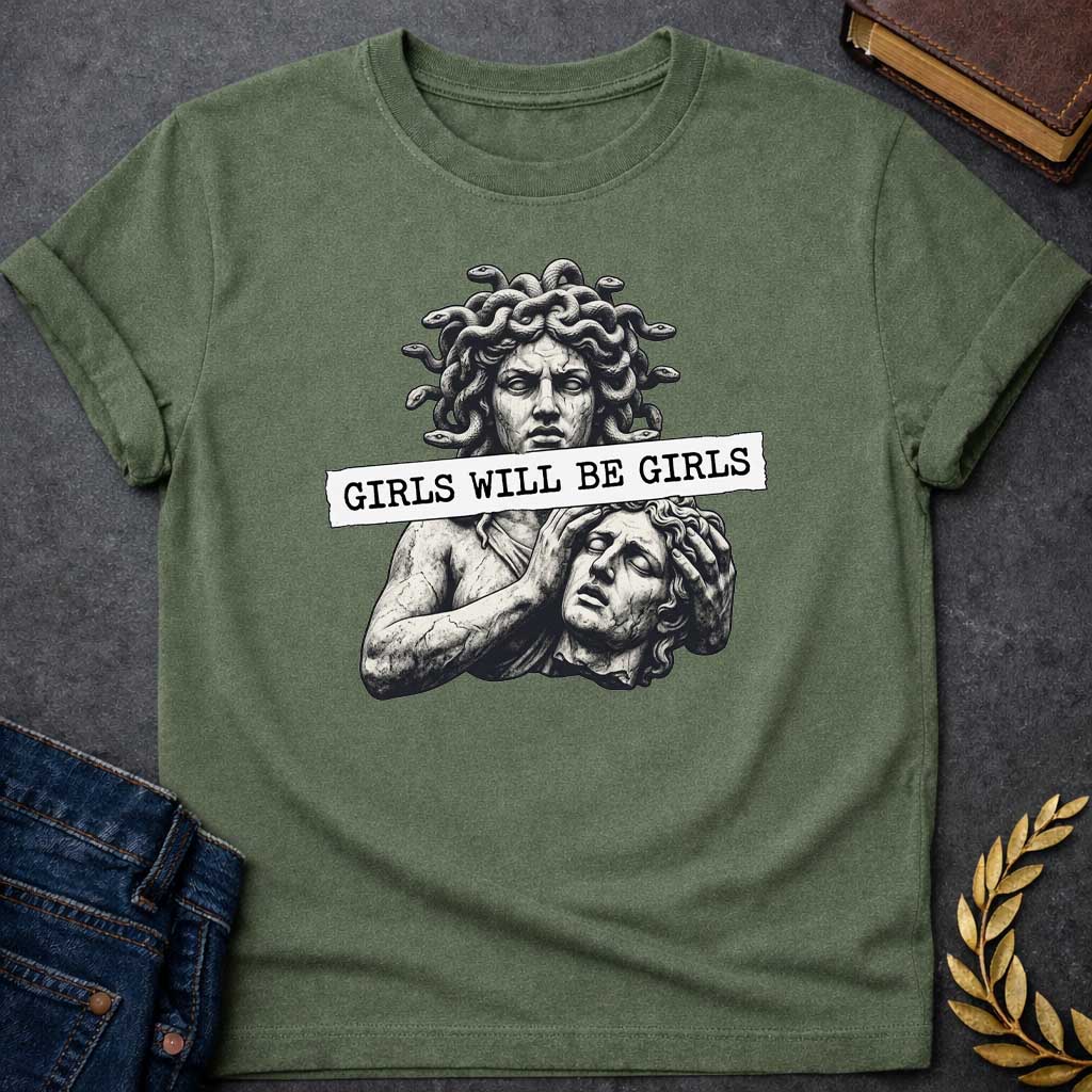 Military Green T-shirt graphic in black and white featuring a detailed stone sculpture-style illustration of Medusa with snake hair looming above a distressed male figure clutching his head in anguish, with a torn paper banner across the middle reading "Girls Will Be Girls" in bold typewriter font — a humorous feminist nod to the Greek mythology story of Medusa