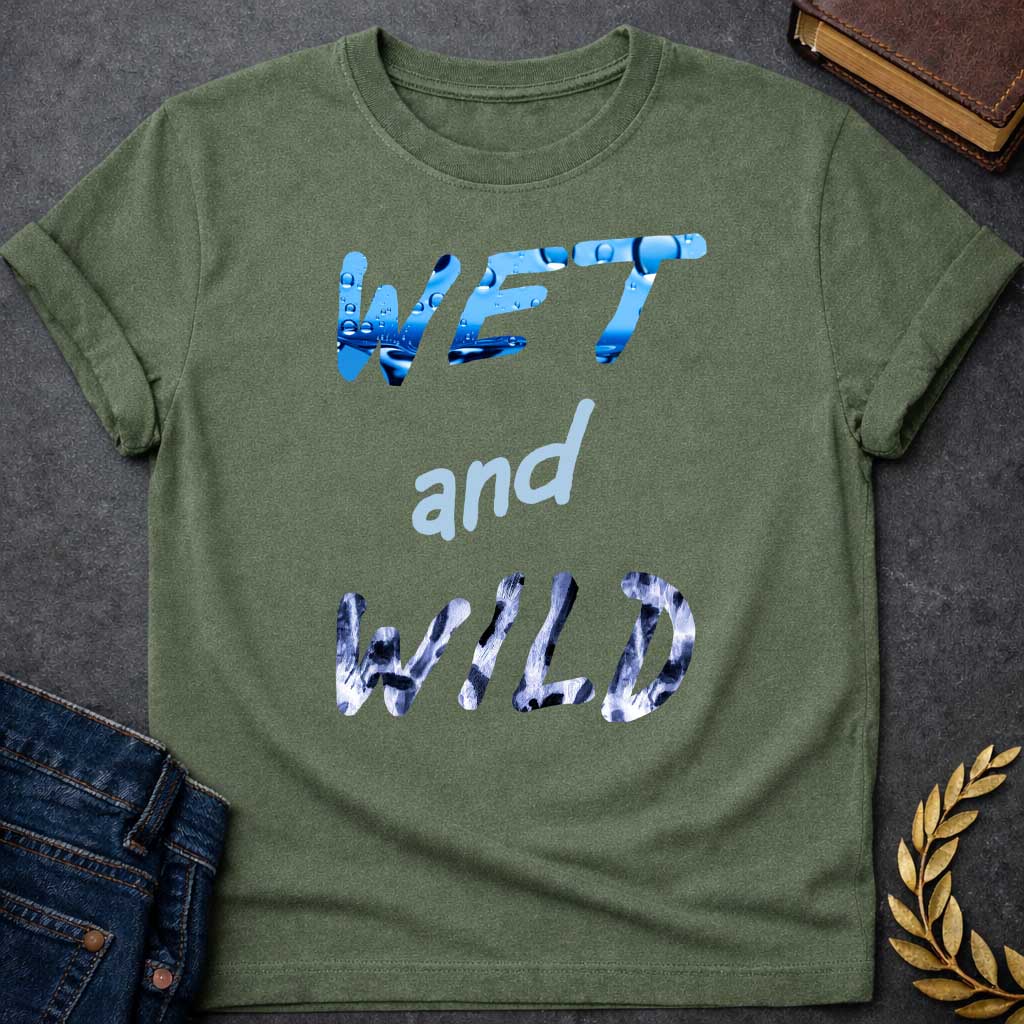 Military Green T-Shirt with a graphic design featuring the phrase "WET and WILD" in three stacked rows. The word "WET" is at the top in a large, bold, sans-serif font. The letters are filled with a high-definition image of bright blue water and splashing droplets. The word "and" is in the center in a smaller, lowercase, light-blue cursive-style font. The word "WILD" is at the bottom in the same large, bold font as "WET," but the letters are filled with a black-and-white leopard or cheetah print pattern
