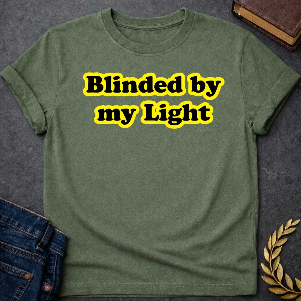 Military Green T-shirt Streetwear graphic design featuring the phrase "Blinded by my Light" in bold black bubble typography with a vibrant yellow glow. Retro-style aesthetic inspired by Greek mythology and Apollo, the god of light