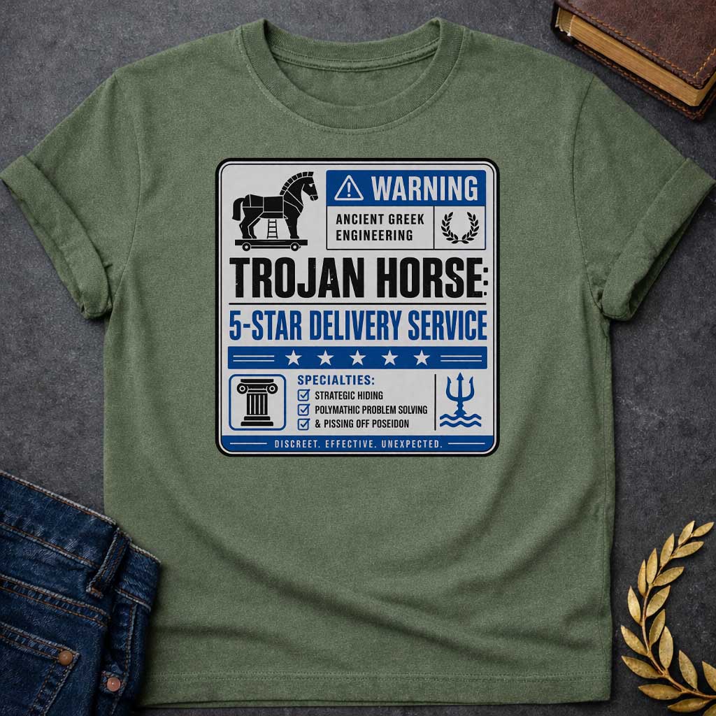 Military Green T-shirt with a graphic designed as a humorous official-style warning sign in grey, blue, and black featuring a flat Trojan Horse icon with a blue warning triangle and the text "Warning — Ancient Greek Engineering" and a laurel wreath in the top section. Bold text reads "Trojan Horse: 5-Star Delivery Service" above a blue five-star rating banner. A checklist below under "Specialties:" reads "Strategic Hiding, Polymathic Problem Solving, & Pissing Off Poseidon" flanked by a Greek column icon an