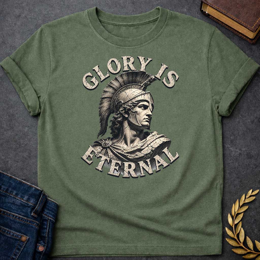 Military Green T-Shirt with a classical illustration of a Greek warrior in profile, rendered in sepia tones with weathered, cracked texture. The figure wears an ornate Corinthian helmet with black horsehair crest, long curly hair, and armor with a draped cloak. The warrior gazes stoically with classical features. Distressed serif letters spell 'GLORY IS' above and 'ETERNAL' below. The design has a vintage, monumental quality reminiscent of ancient statuary, emphasizing themes of heroism, honor, and timeless