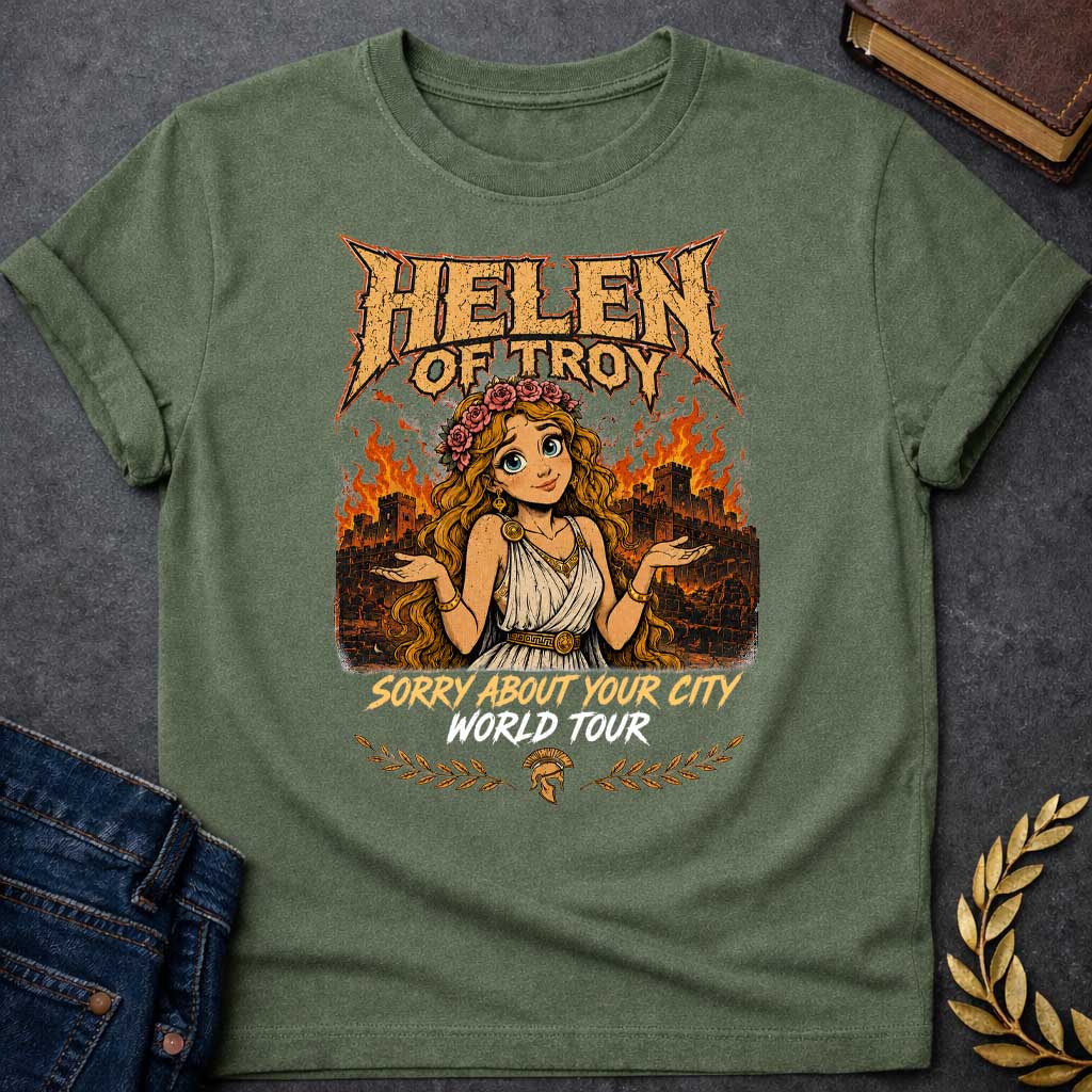 Military Green T-shirt with a heavy metal style graphic featuring a cartoon Helen of Troy with big blue eyes and a flower crown. She shrugs playfully while standing in front of a burning ancient city wall. At the top, "HELEN OF TROY" is written in a jagged, metallic font. Below her, the text reads "SORRY ABOUT YOUR CITY" in gold and "WORLD TOUR" in white brush script, accented by a Spartan helmet and laurel leaves.